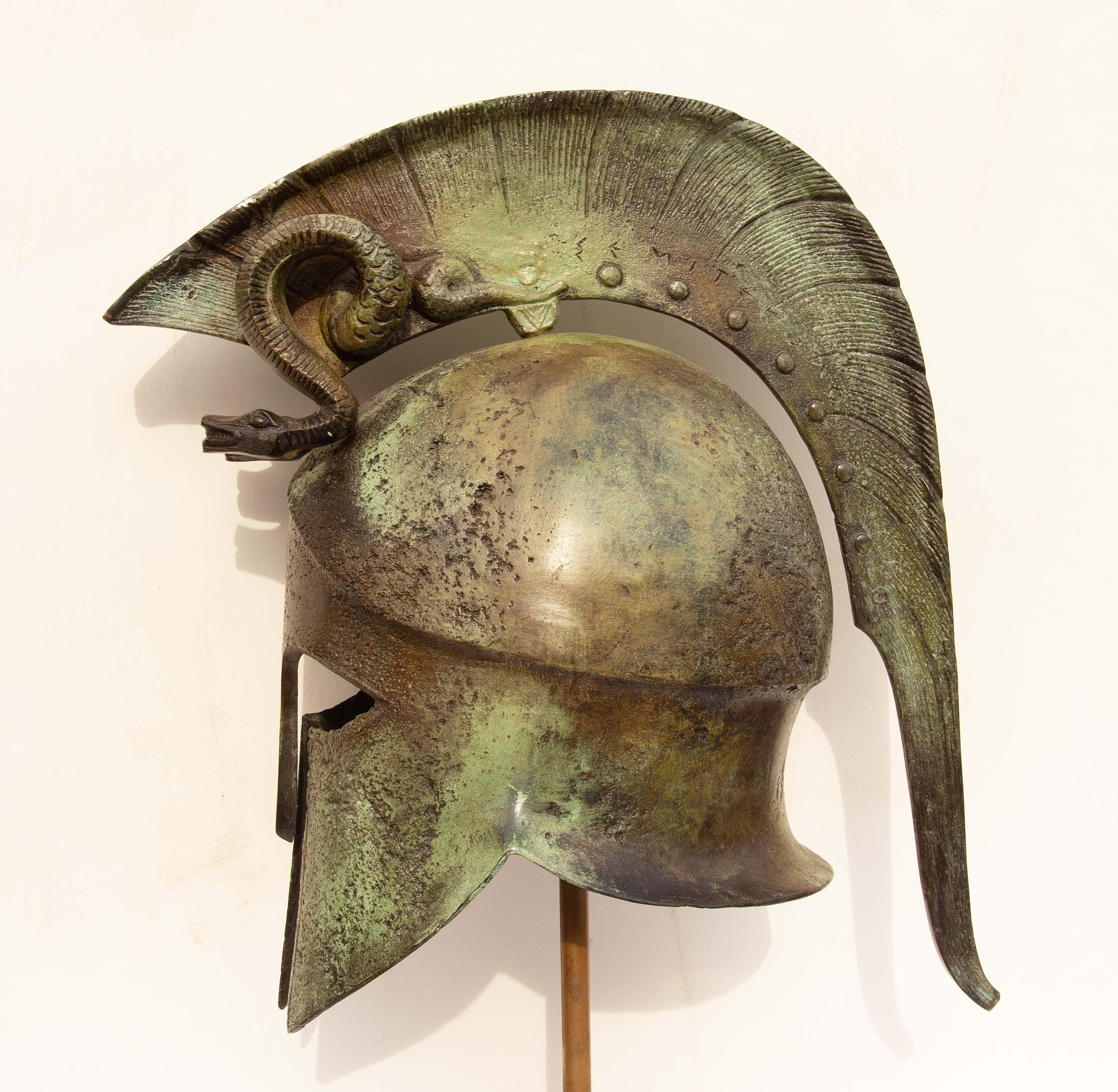 Bronze Spartan Corinthian helmet mounted on brass and marble museum stand, 20th century.