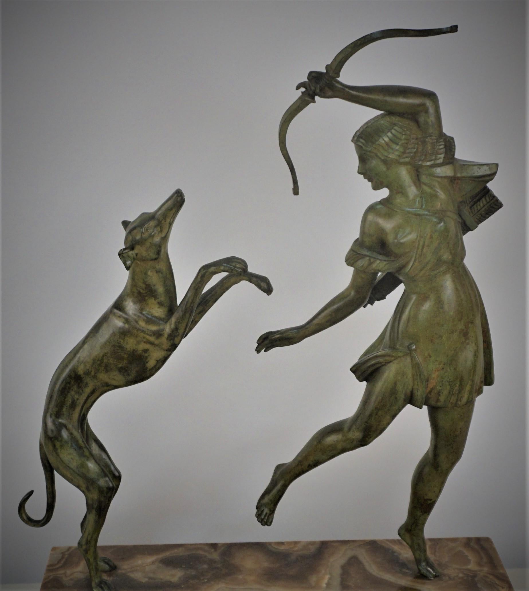 Art Deco sculpture of Diane the Hunter with Dog in green, brown patinated bronze standing over textured brown onyx.