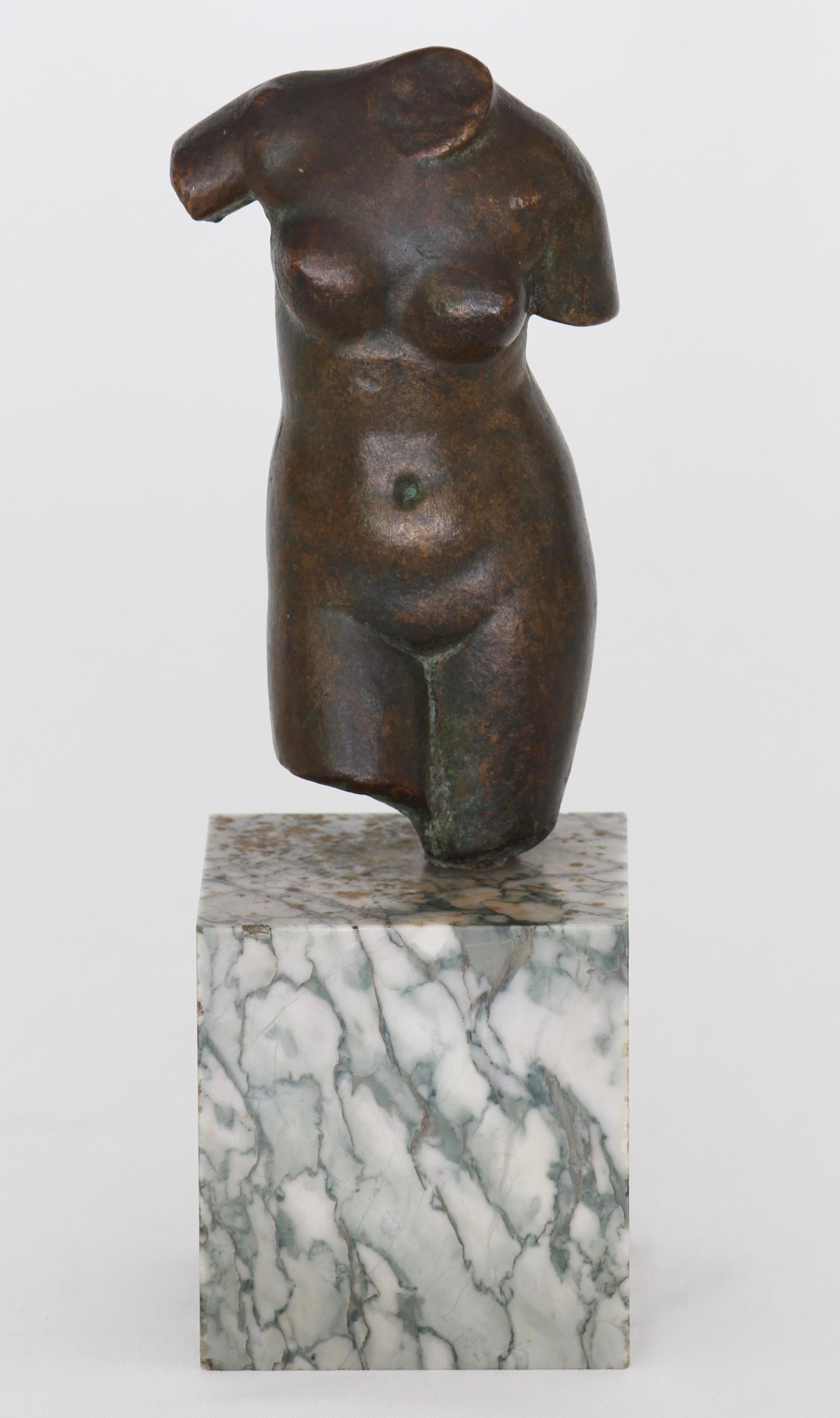 A small solid patinated bronze classical figure of a nude female torso mounted on a marble base.