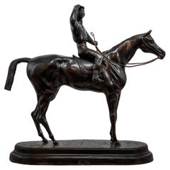 Bronze statue of a jockey on a horse sign Valton