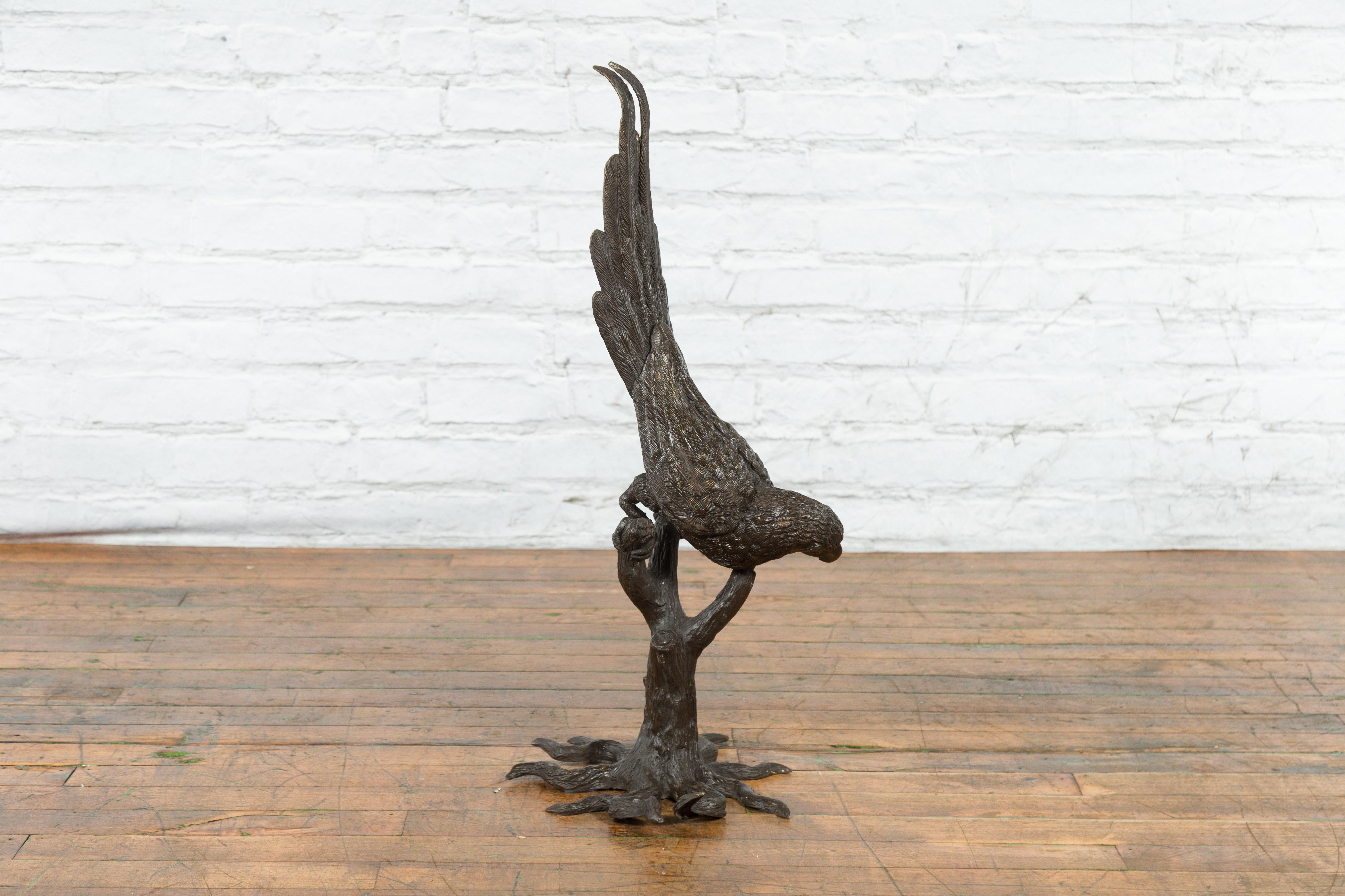 Cast Bronze Statue of a Parrot Perched on a Branch and Leaning Down, with Dark Patina For Sale