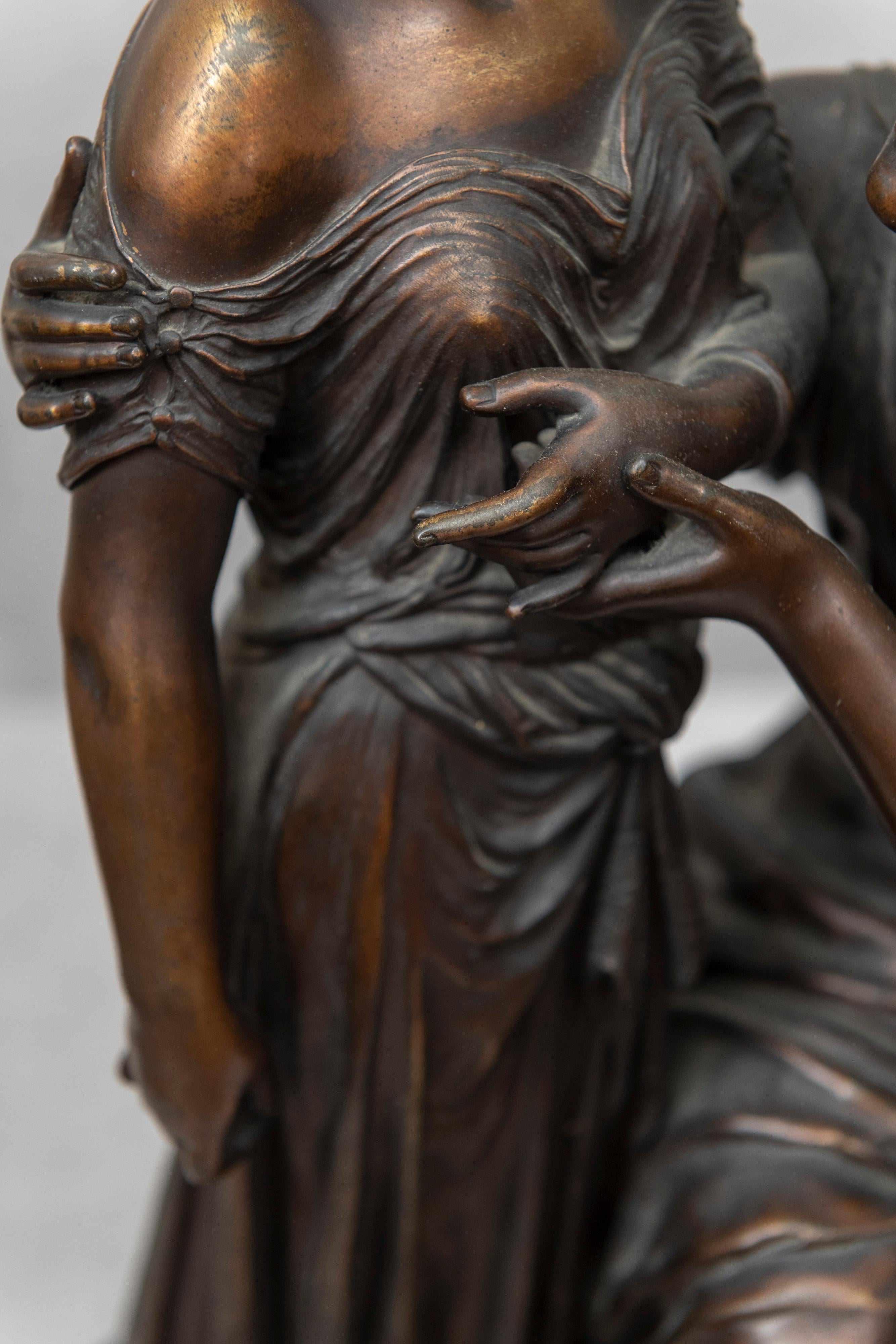 man kneeling to woman statue