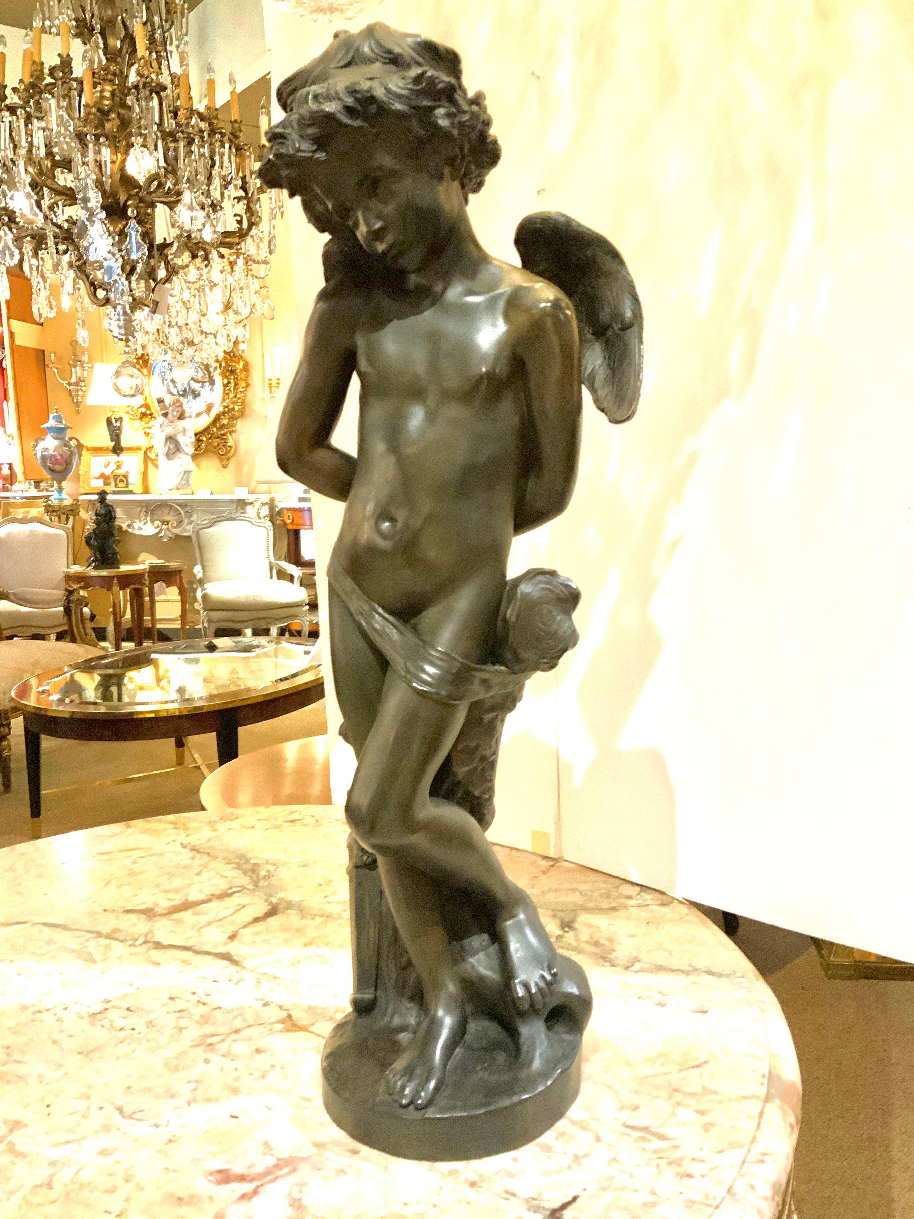 This bronze is a figure of Cupid with his hands tied behind his back.
The face is sweet with a demure smile. It was sculpted by the artist
Denise Delayigne in France. It is 19th century and signed a the base
Delayigne. The patina is original and