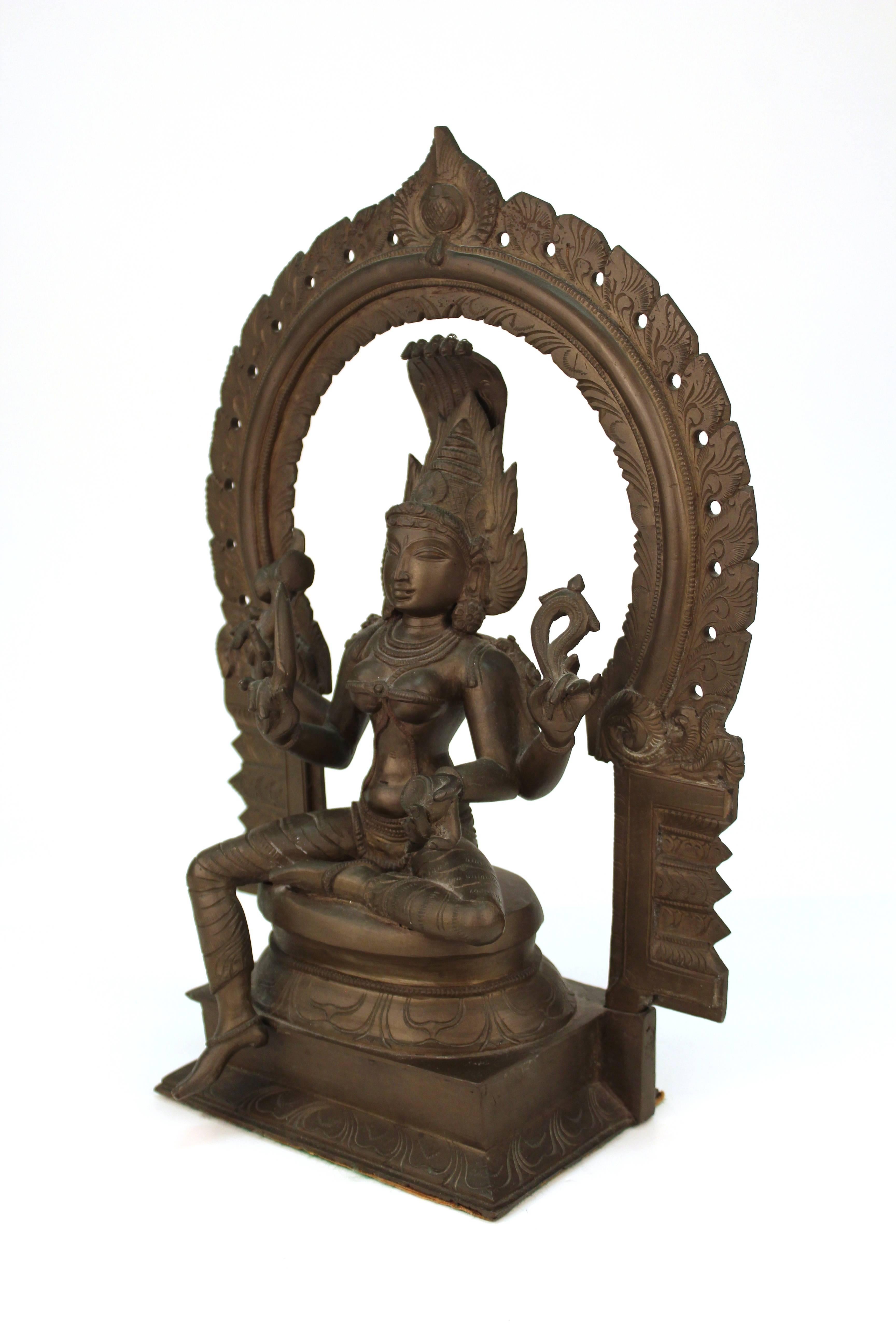 Bronze statue of Kali, the Hindu goddess of time, creation, power and destruction, seated on a lotus throne and holding various symbolic attributes. The piece is in great vintage condition.