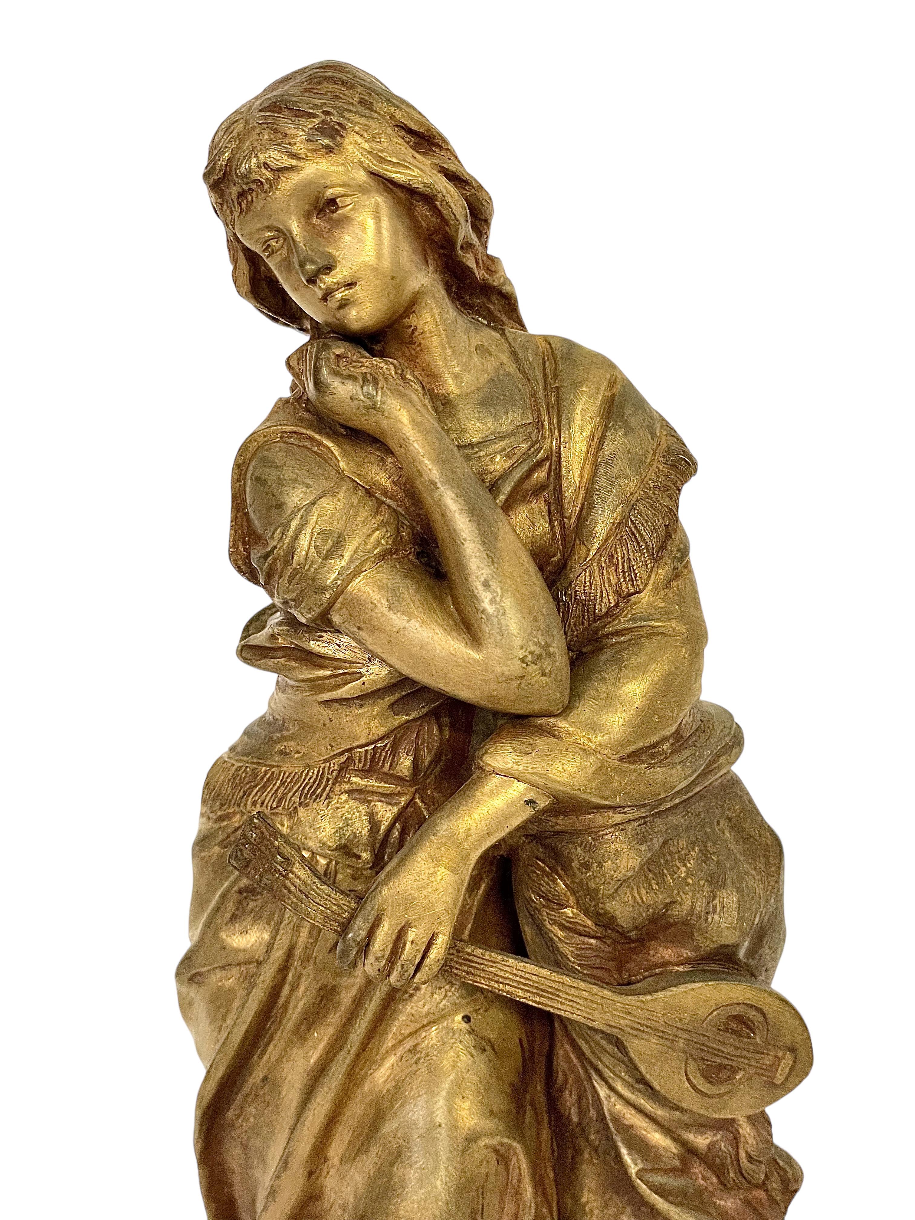 Adrien-Étienne GAUDEZ (1845-1902). “Mignon”. A superb late 19th century patinated bronze statue of a young girl leaning against a tree, holding a lute. The young girl, Mignon, is modelled on a character from the 'opéra comique' of the same name, an
