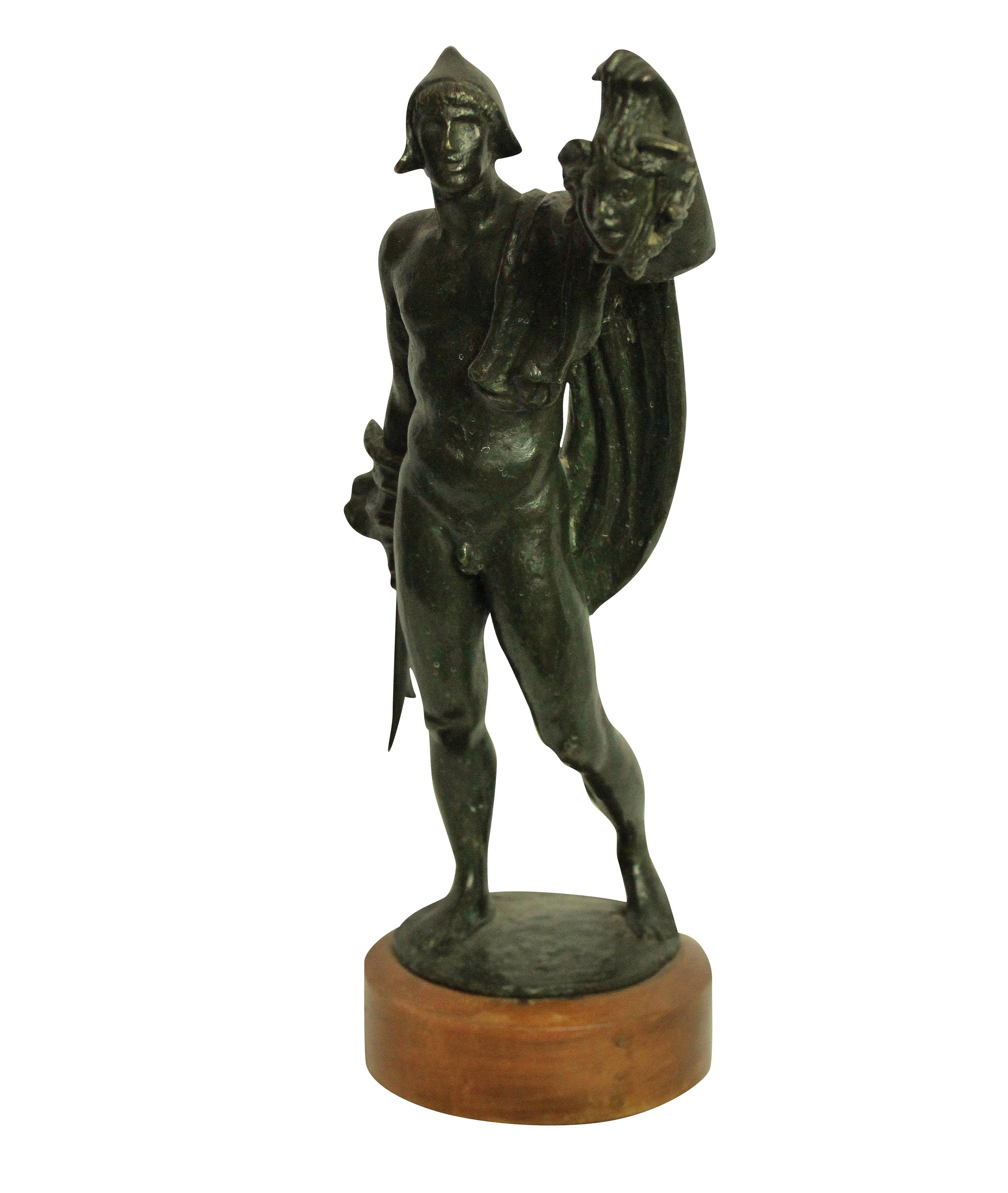 An Italian bronze statue of Perseus holding up the head of Medusa.