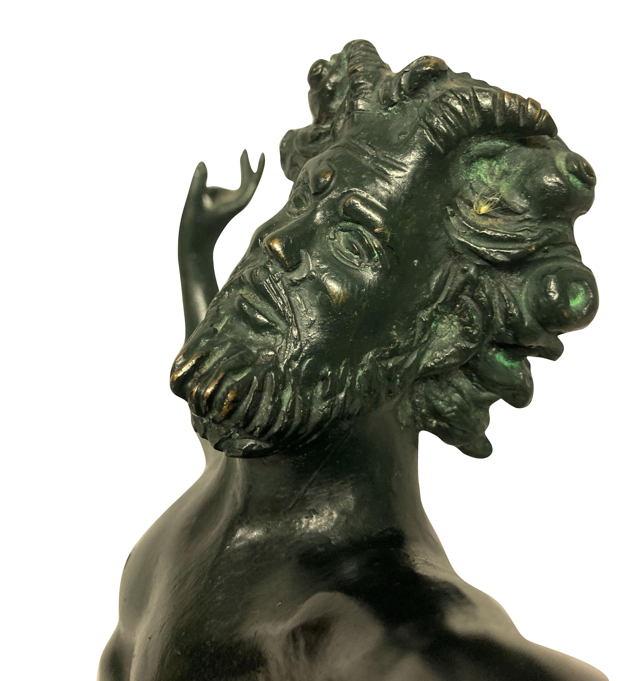 An English green patinated bronze statue of the dancing faun. This classic sculpture of the dancing faun was originally found in Pompeii after it’s excavation during the XVIII century and became copied for The Grand Tour market.
