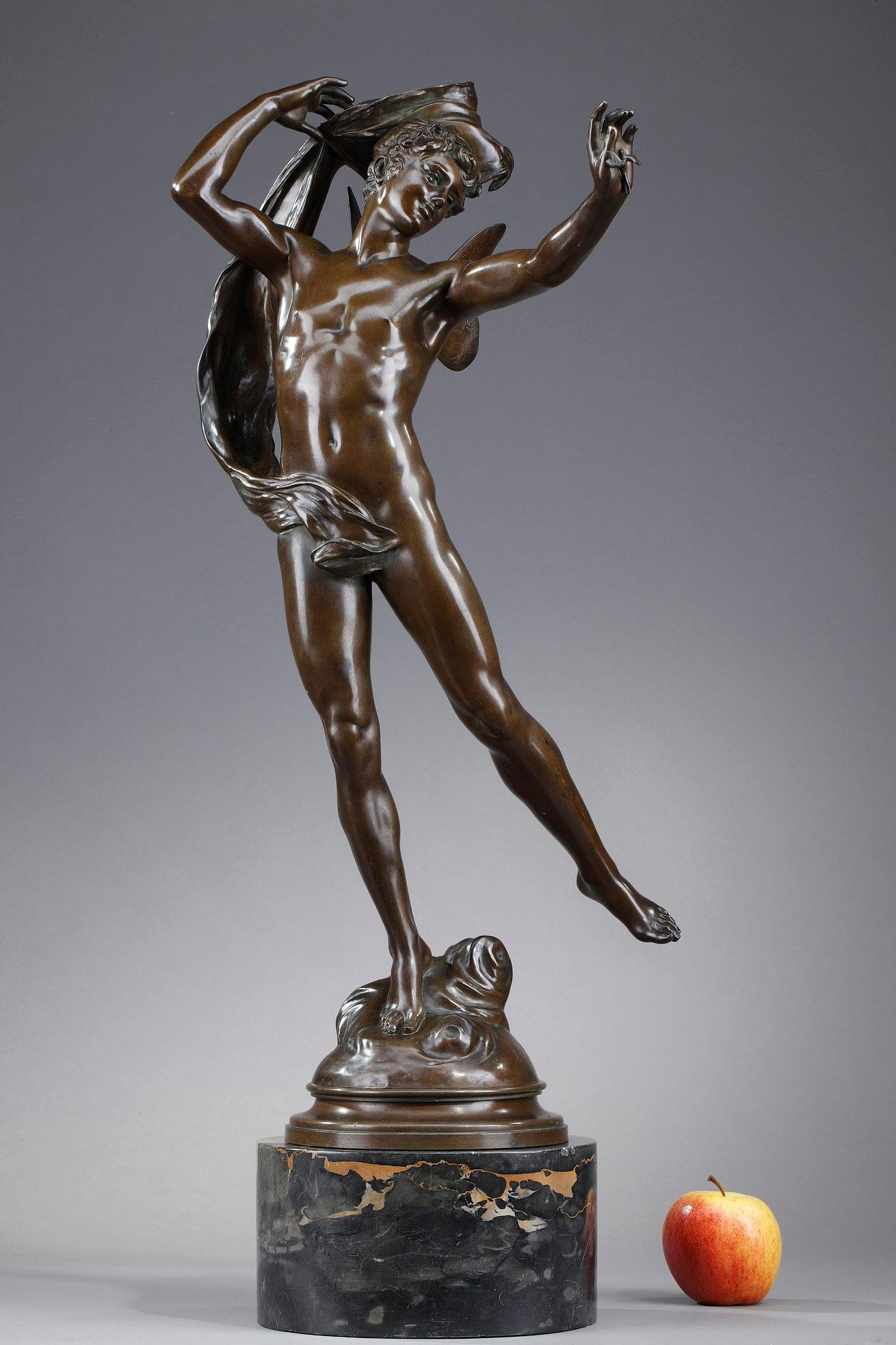 This bronze statue with a shaded brown patina is signed Eugène Marioton (1854-1933) and represents a winged man with a slender posture. The naked young man holds a light sheet in his right hand and a dragonfly in the other. His butterfly wings on
