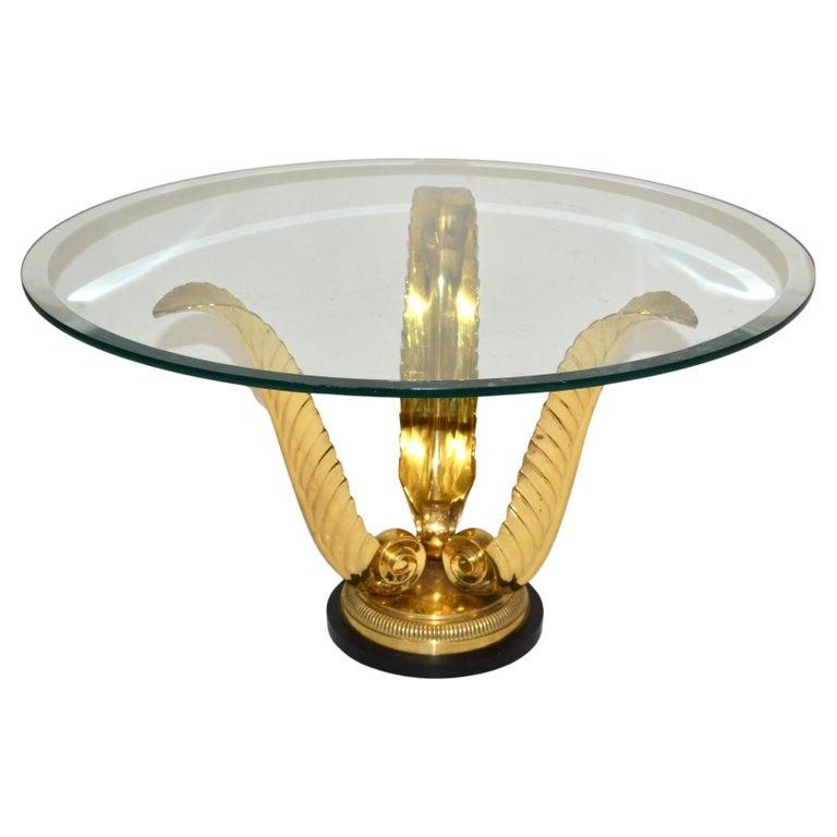 Round Agave Table with beveled Glass Top from Italy made in the 1970.
Three Scrolled handcrafted Brass Agave leaves mounted on a Round Steel & Bronze Base.
We used for the picture a 26 inches round beveled Glass Top but can be modified to Your