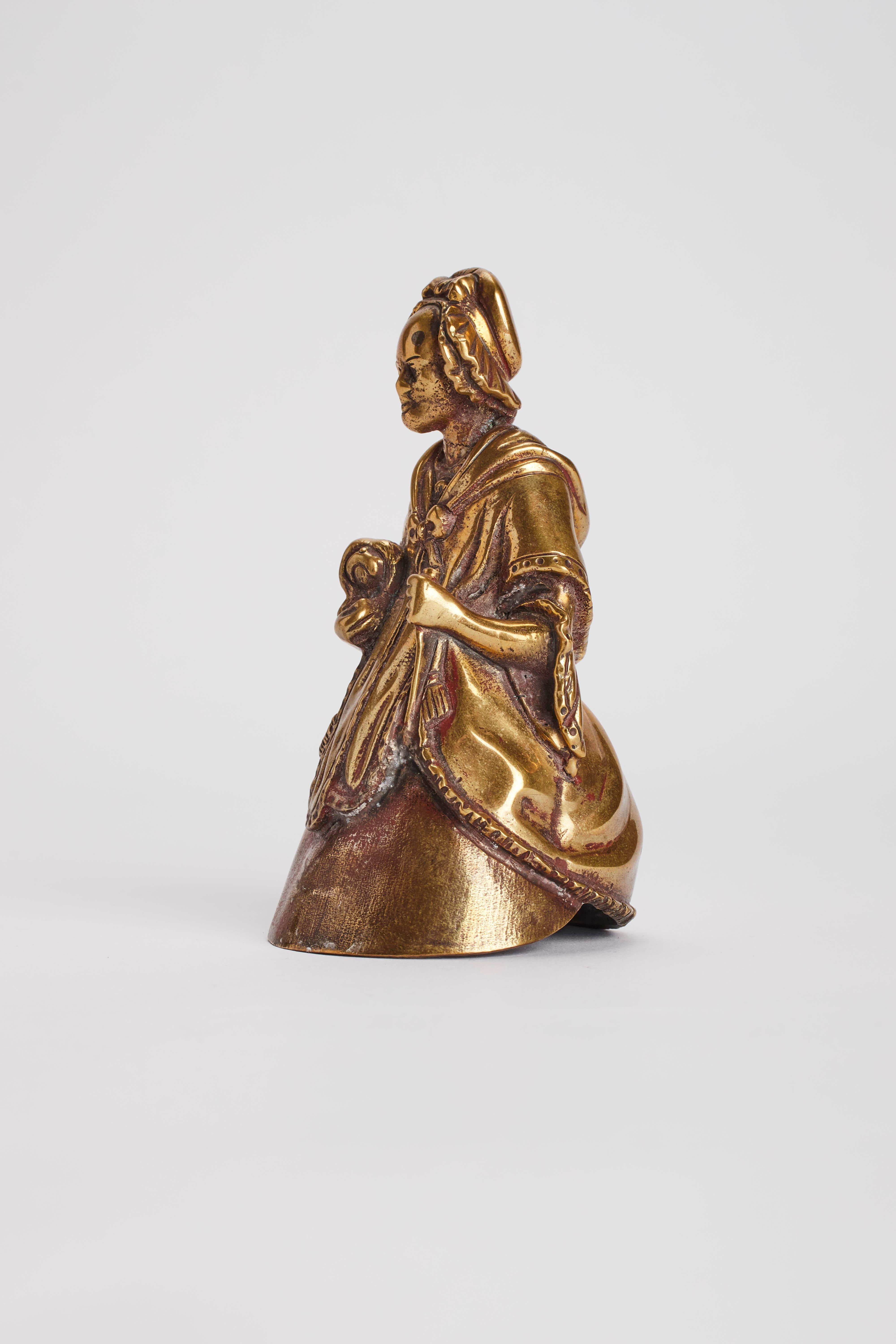 Vintage antique bronze table bell, depicting an old women. London, 1880 ca.