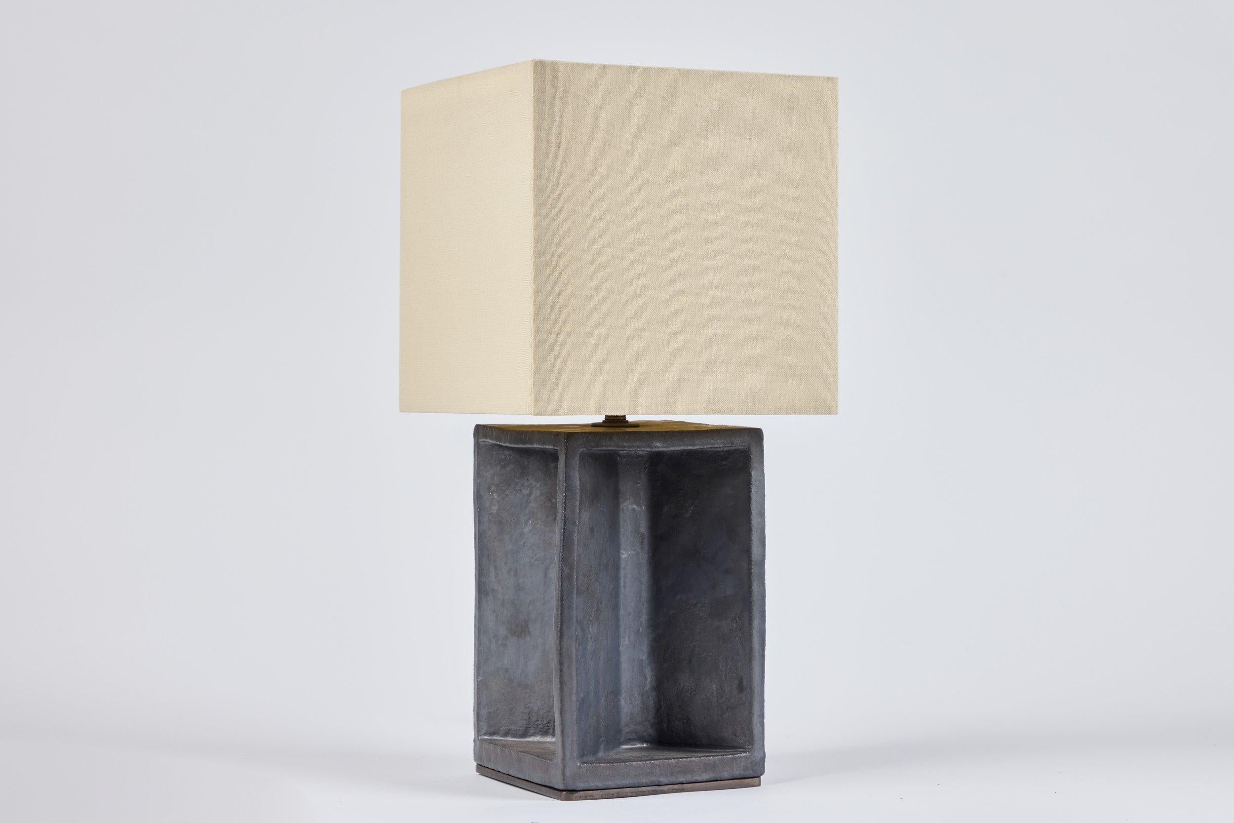  Dark bronze table lamp with custom linen shade. 6 available.  Measures 6