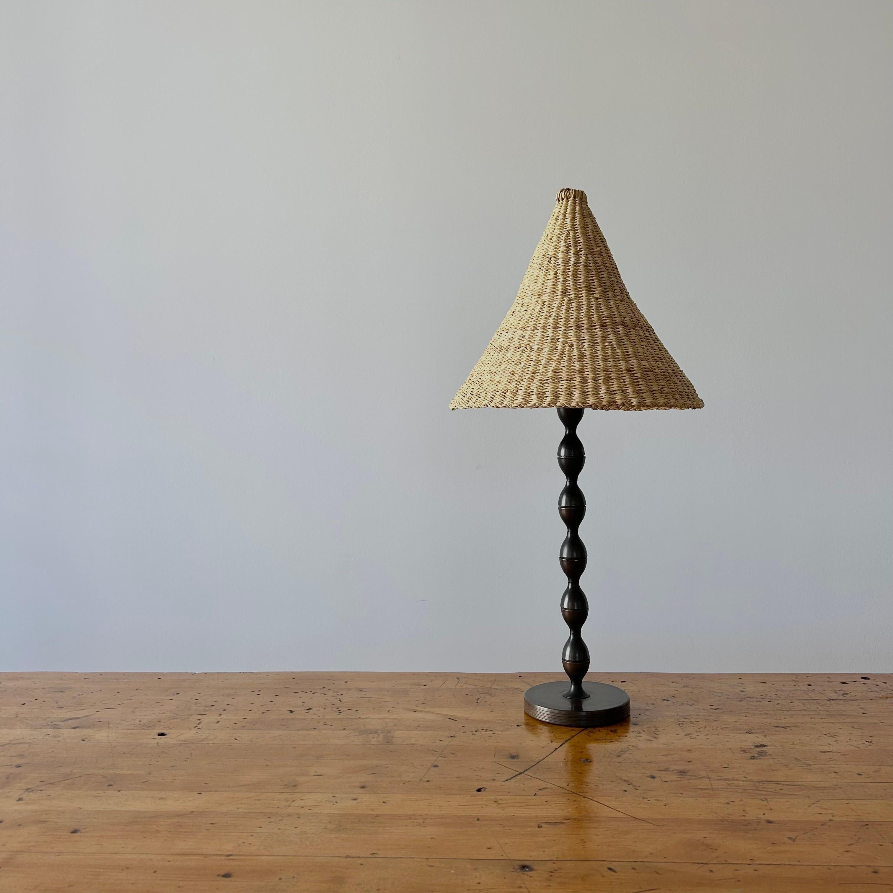 A charming vintage bronze table lamp, rewired in LA and refreshed by our handwoven elephant grass shade. Good vintage condition.

Light shade handwoven by a women's organization for traditional arts in northern Ghana, emits a warm diffuse