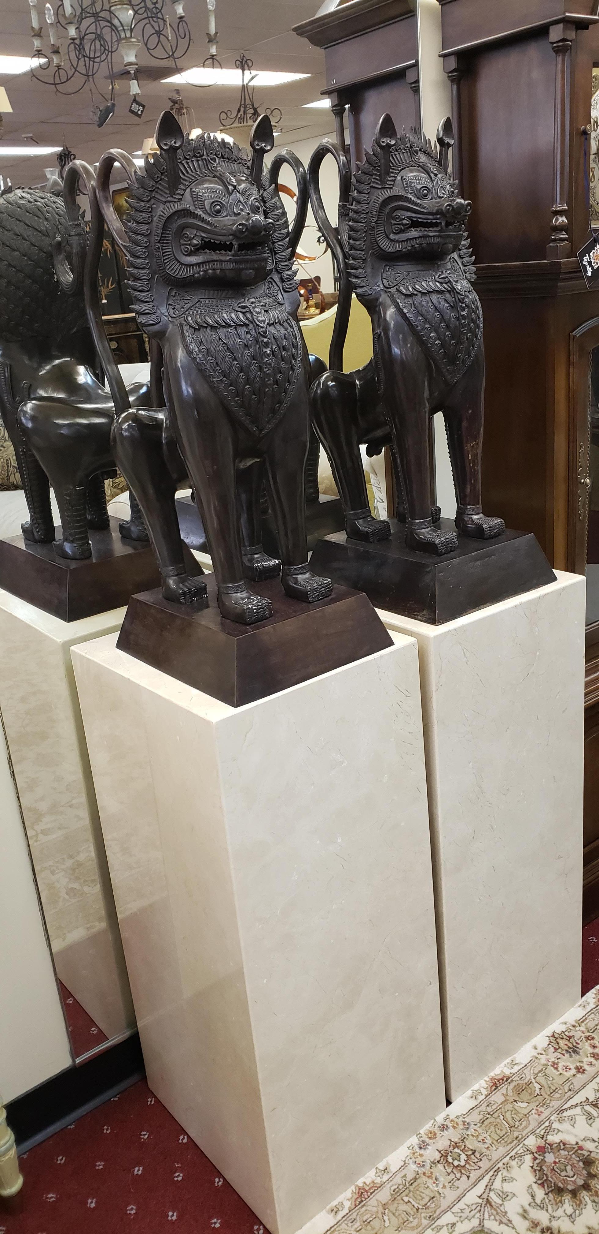 Pair of bronze cast Foo Dogs on a marble pedestal. The pair will guard your entryway or any space in your home.
Guardian lions, also known as komainu, shishi, or foo dogs, are intimidating, mythical, lion-like creatures. They symbolize prosperity,
