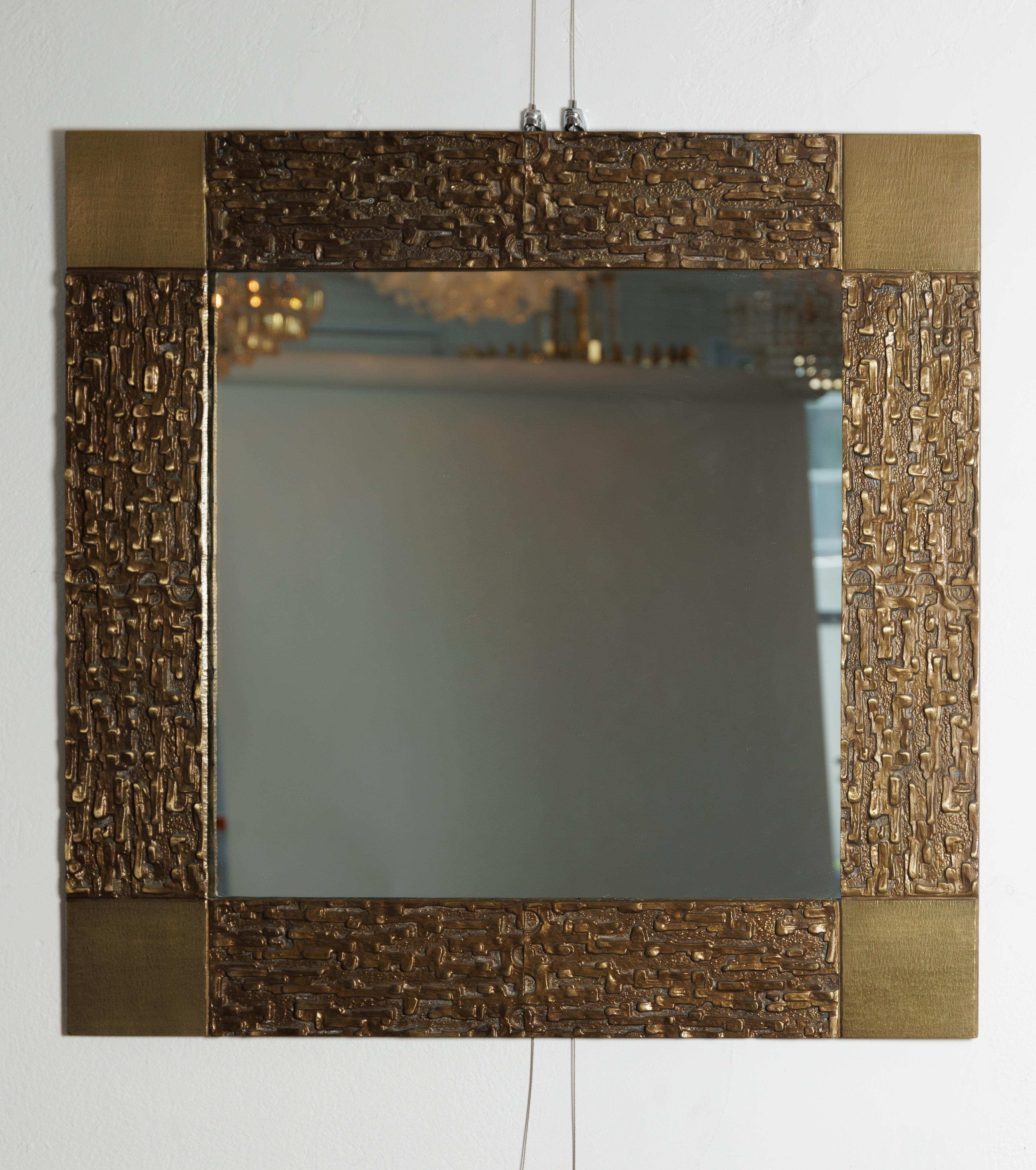 Square bronze surround mirror with sculptural detailing.
Attributed to, Frigerio.