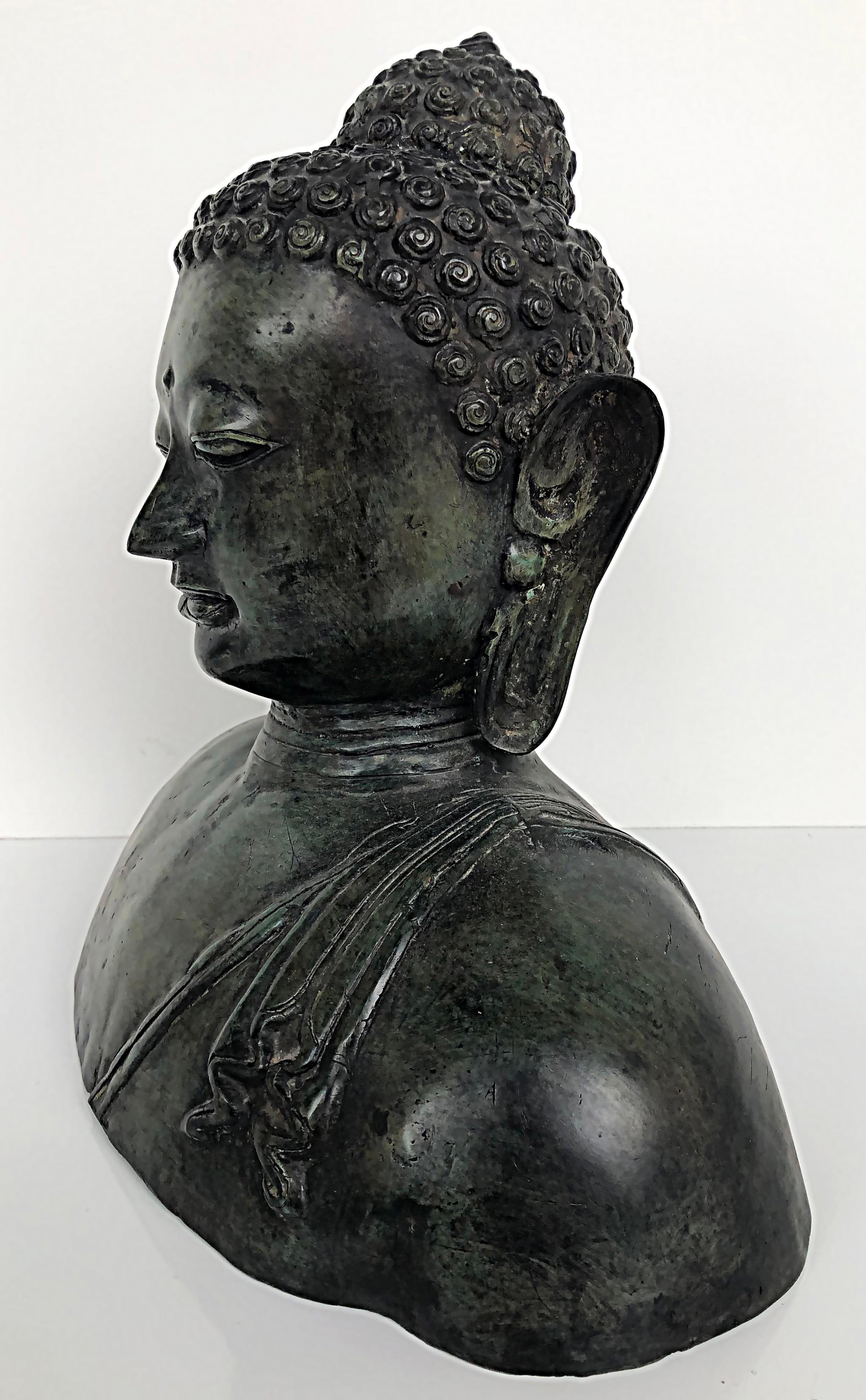 Bronze Thailand figurative buddha sculpture bust, 20th century with patina.

Offered for sale is a large and substantial bronze Buddha bust from Thailand. The bust is 2oth-century and has a rich dark green applied patina. The detail is lovely and