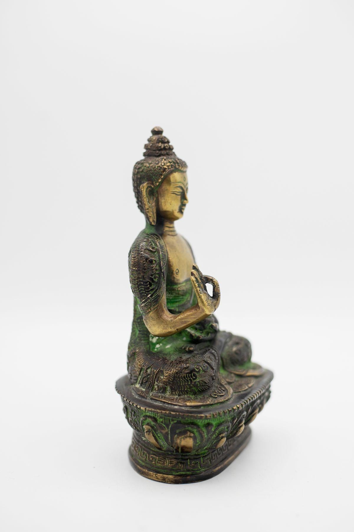 A rare 19th century Tibetan bronze statue depicting the Buddha in the 'healing' posture. He is depicted with a happy and relaxed expression, like the gaze of a carefree person who is doing good, rising above human nature.
This statue is ideal for