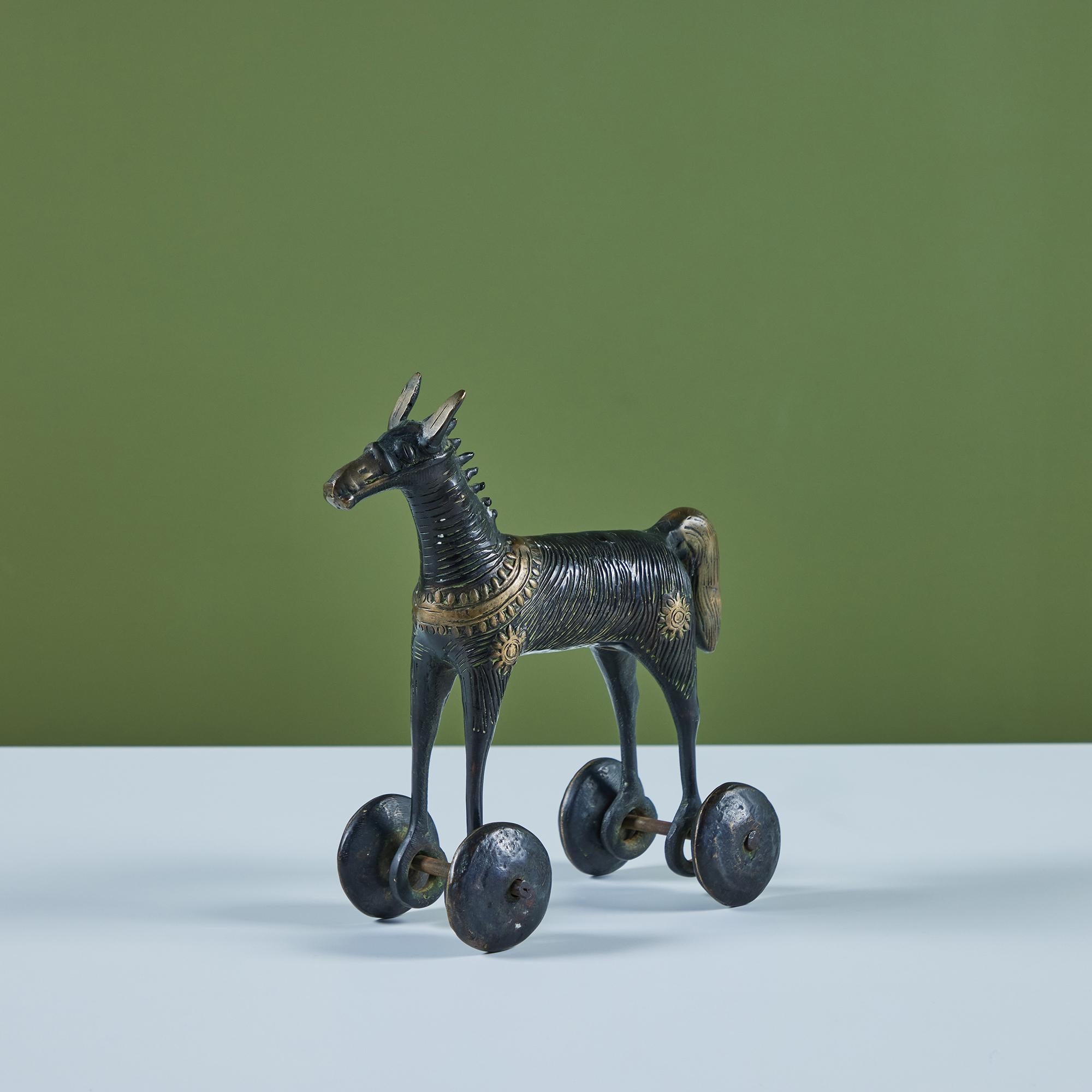 Cast bronze toy horse on four wheels. Reminiscent of early 19th century Indian toys, these pieces were often left as offering in temples for children to find. The gift of the horse to the Gods was believed to leave one in high standings. This one is
