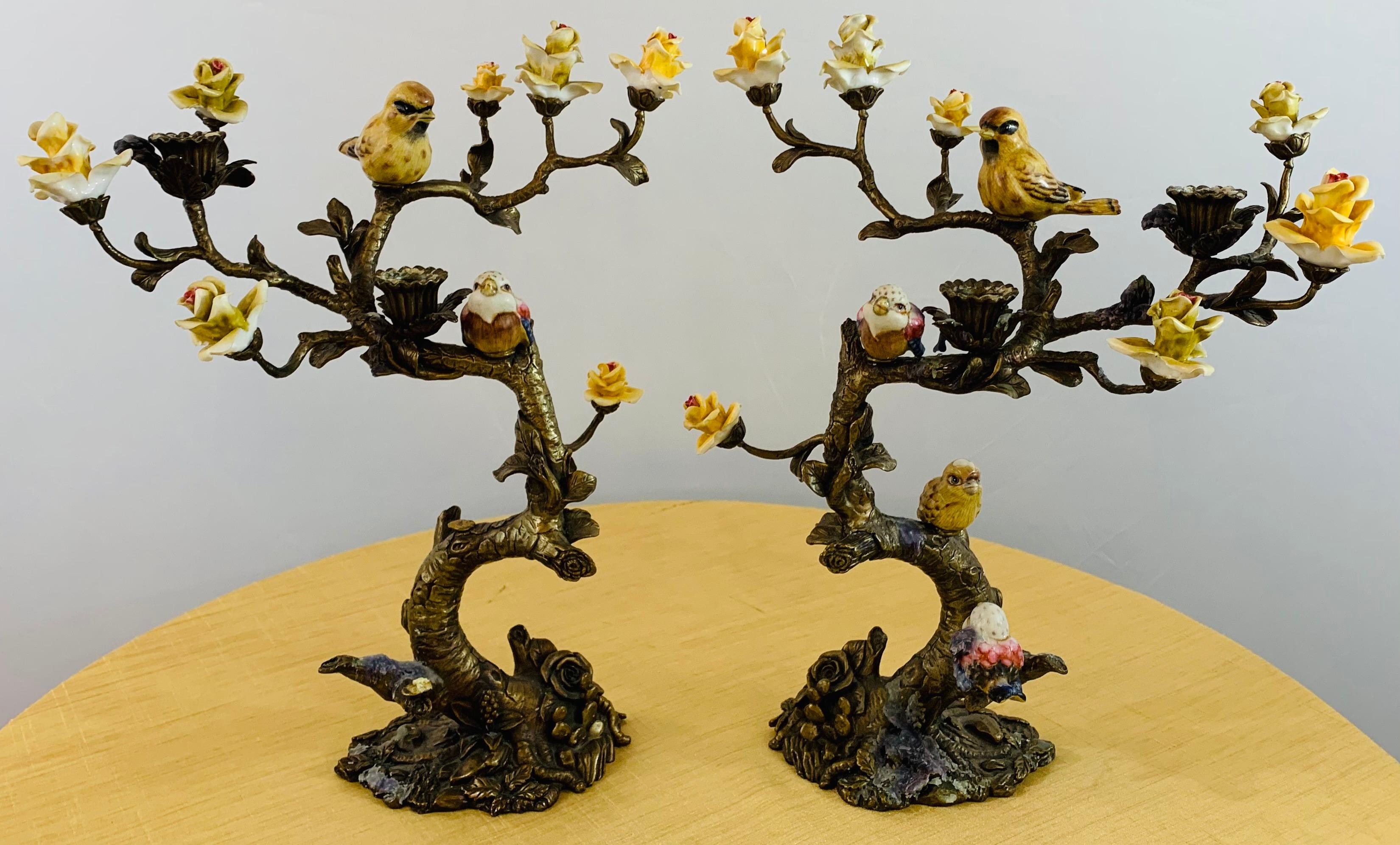 A beautiful pair of candleholders / candelabras crafted in Bronze in a shape of a tree with colorful ceramic flowers and birds. Each candelabra can hold two candles. This pair will add style to your dining experience and create an amazing ambiance