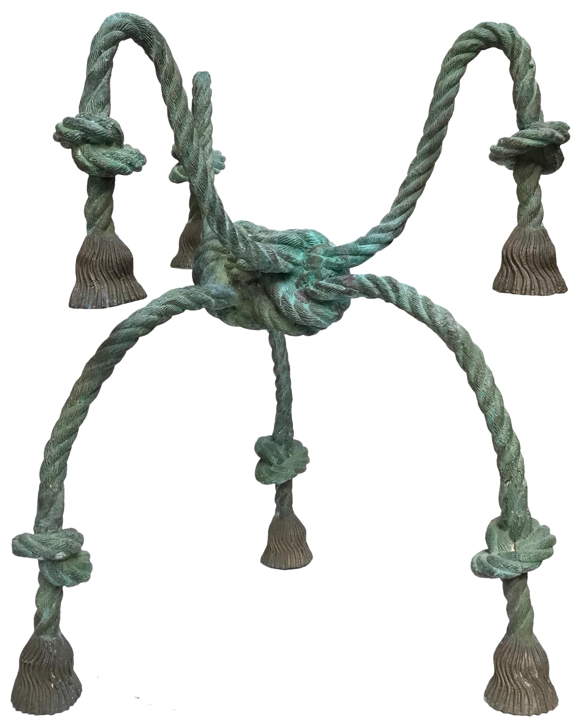 A wonderful, solid bronze trompe l'oeil rope with tassels, table base. Fantastic quality casting and details as well as a rich and warm, applied green patina. A beautifully executed, surrealist, nautical inspired concept with an elegant and alluring