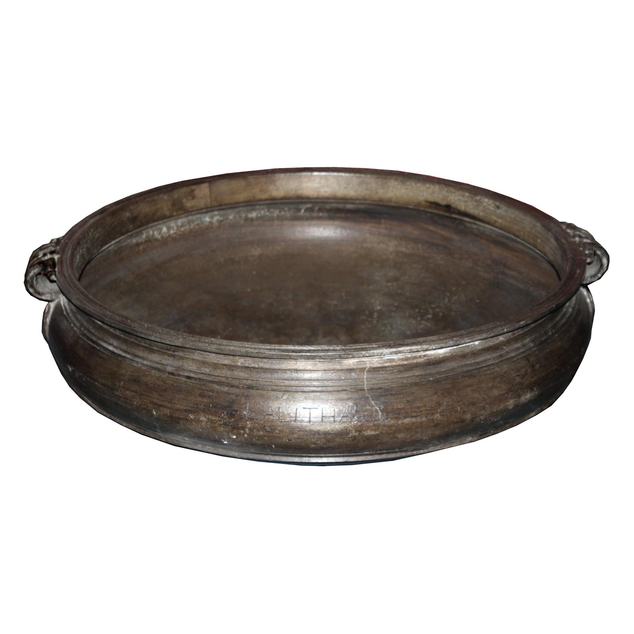 19th C bronze urli (cooking vessel) from Southern Indian used for cooking in festivals and wedding ceremonies. Urli can be used as an outdoor fire pit, a dramatic centerpiece filled with water and rose petals or as a container for orchids or plants.