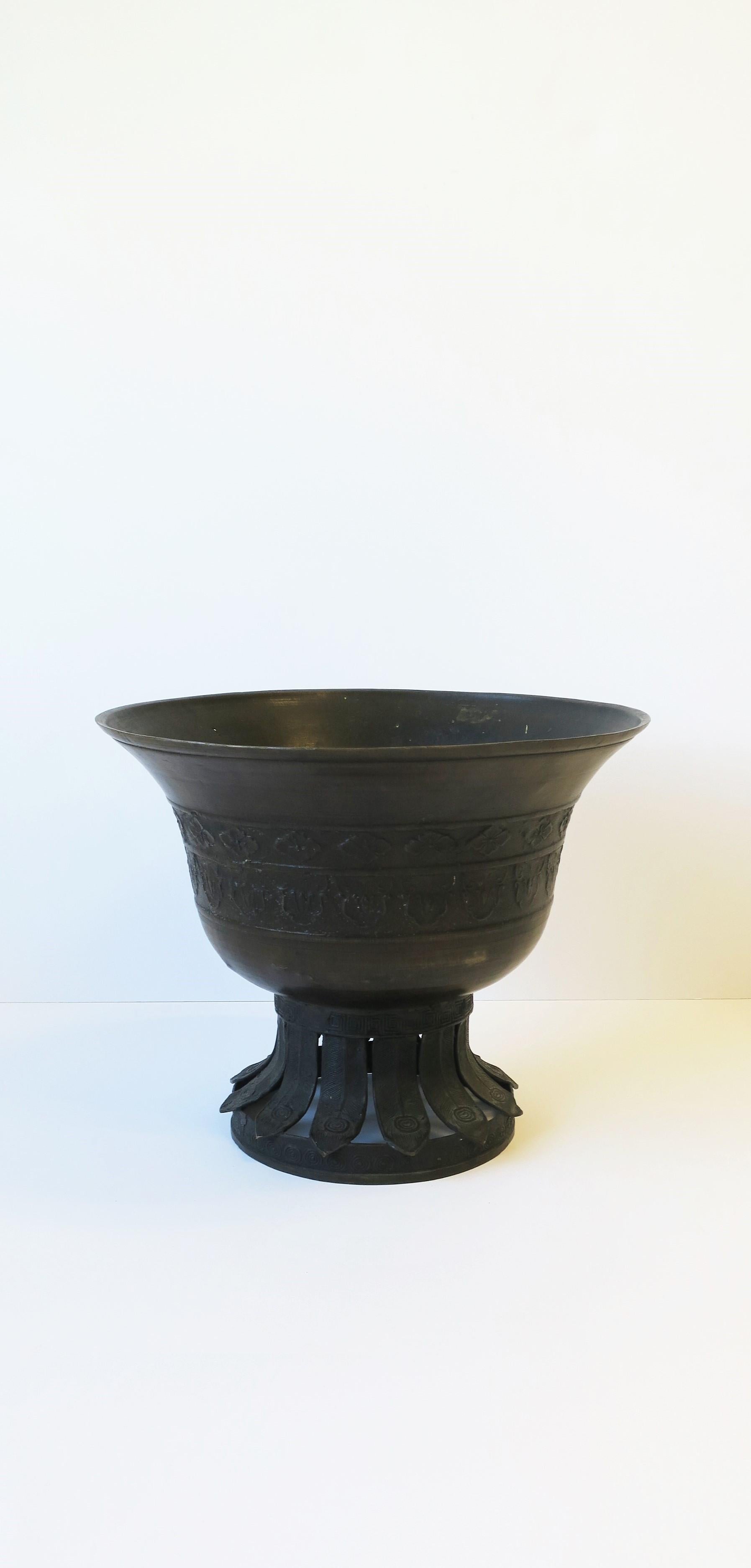 A bronze Jardinière Cachepot with beautiful decorative base, circa 20th century. Beautiful as a standalone piece or as an overpot for flowers or plant. Shown with tulip flowers in image #4 and 5 (pot can handle larger/more plant/flower than what is