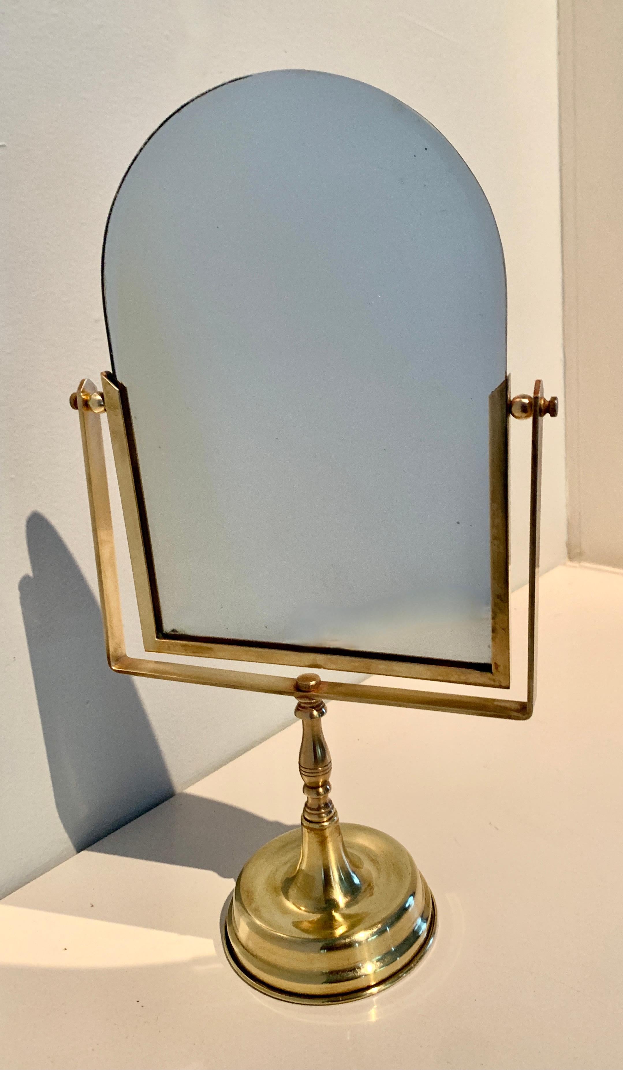 A bronze table mirror on stand. This piece was heavily patinated and has been polished to a key shine. The piece, over time will tarnish into a lovely patinated finish if not polished. The mirror is very well made and of good quality, one small