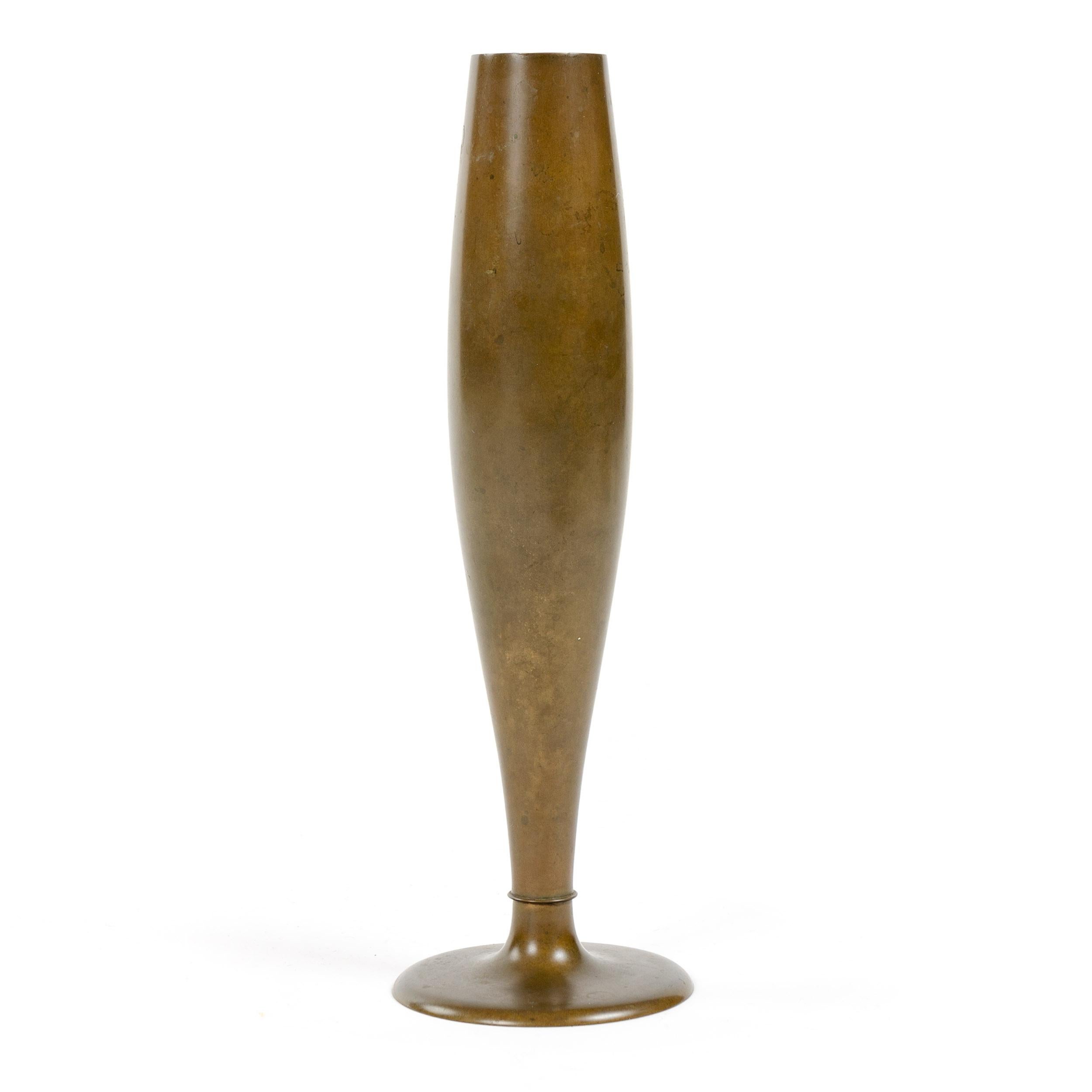 A slender bronze bud vase of fluid form having a warm patina.