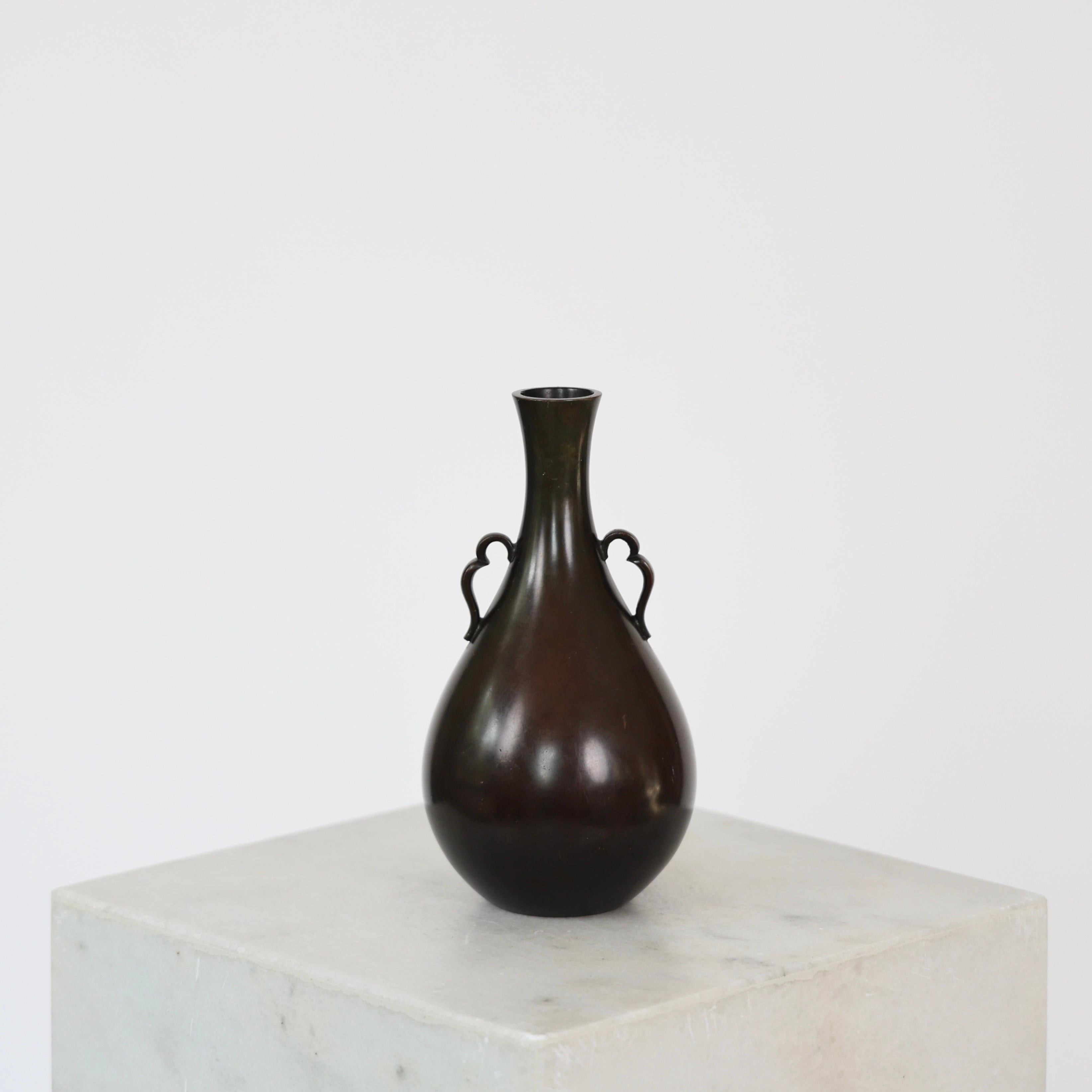 Drop-shaped Bronze Vase designed by Just Andersen in the 1930s. 

* Drop-shaped bronze vase with lugs
* Designer: Just Andersen 
* Style: B1746
* Year: 1935
* Condition: Very good vintage condition. Makers engravings intact. Dark patinated bronze