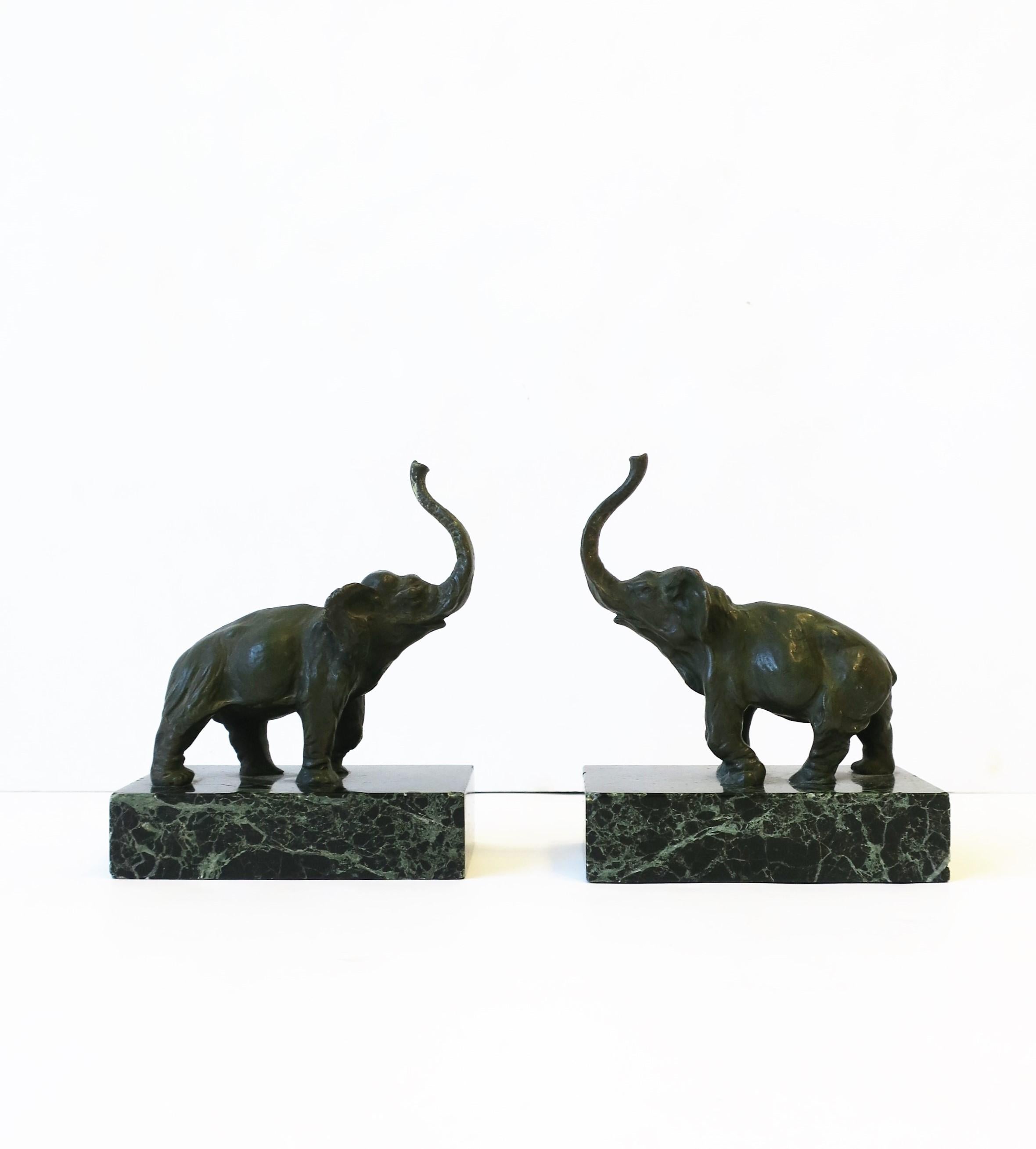 A substantial pair of bronze verdigris elephant bookends or decorative objects, circa mid to late-20th century, 1970s. Substantial bronze verdigris elephant's atop dark green marble bases. Dimensions: 3.07