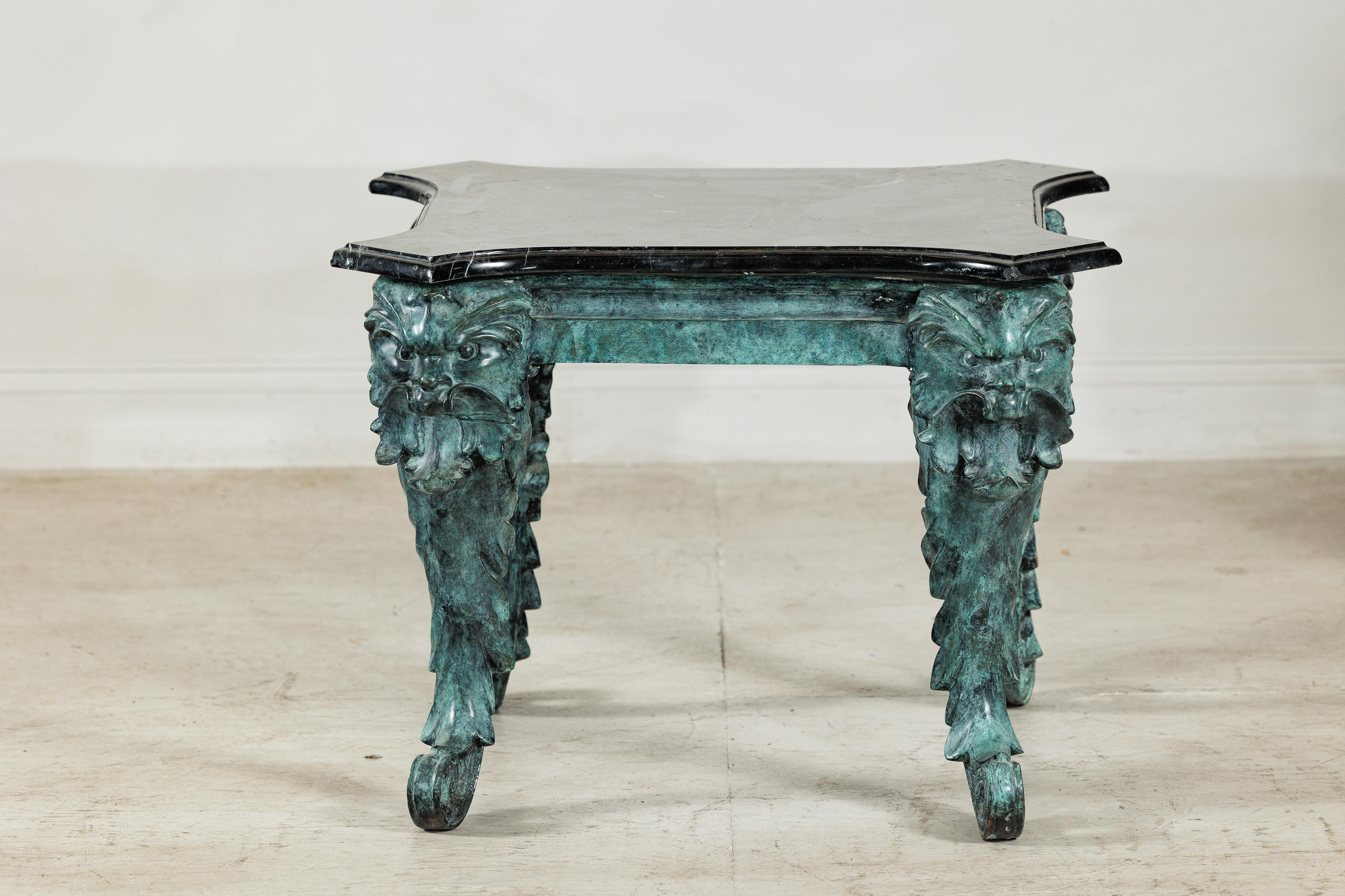 Hollywood Regency Bronze Verdigris Table with Black Marble Top and Sculptural Mask Legs en vente