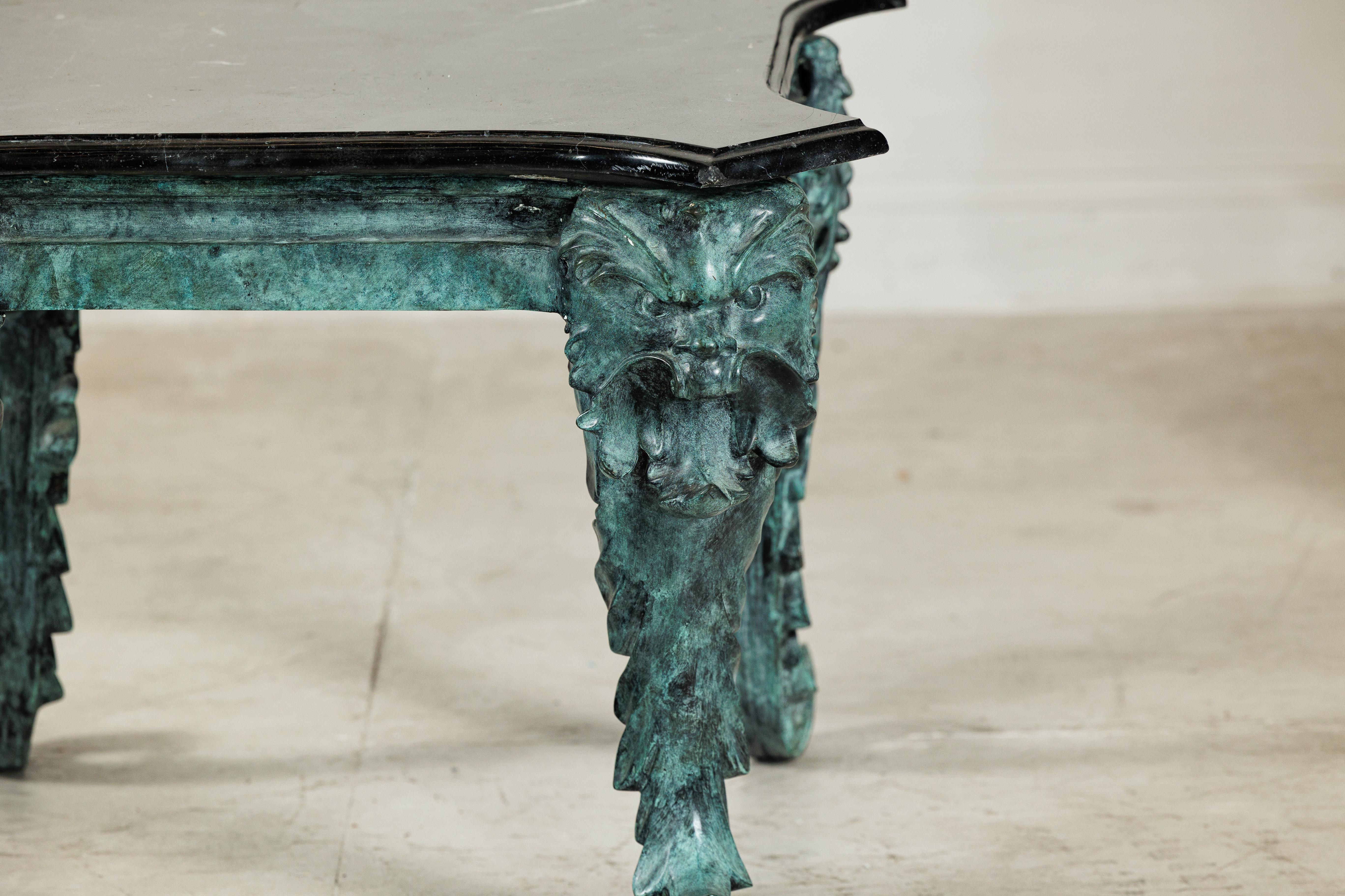20ième siècle Bronze Verdigris Table with Black Marble Top and Sculptural Mask Legs en vente
