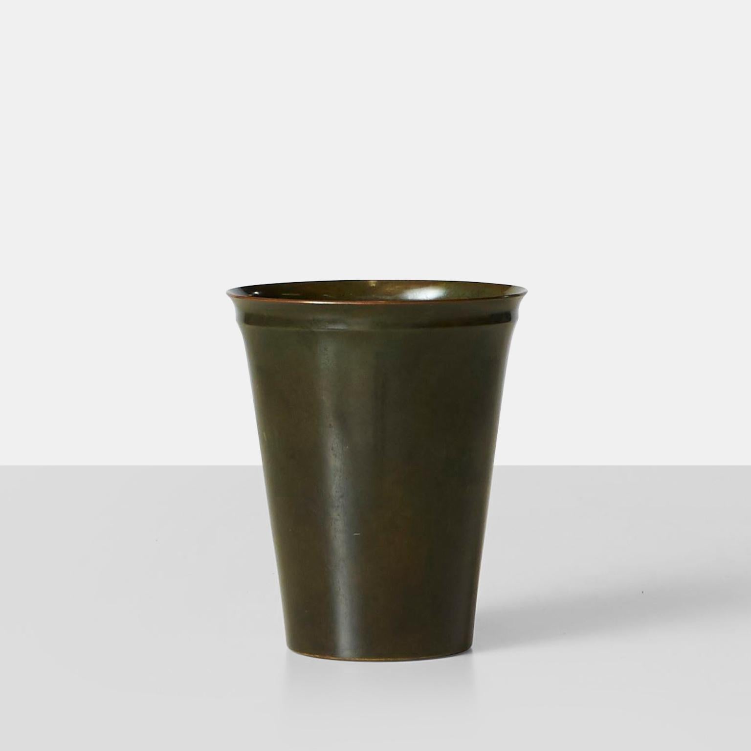 A bronze vessel by Just Andersen for his own bronze works. Flared rim with interesting detail just below the rim. The object has a beautiful patina and some very slight scuffs reflecting the age of the piece.