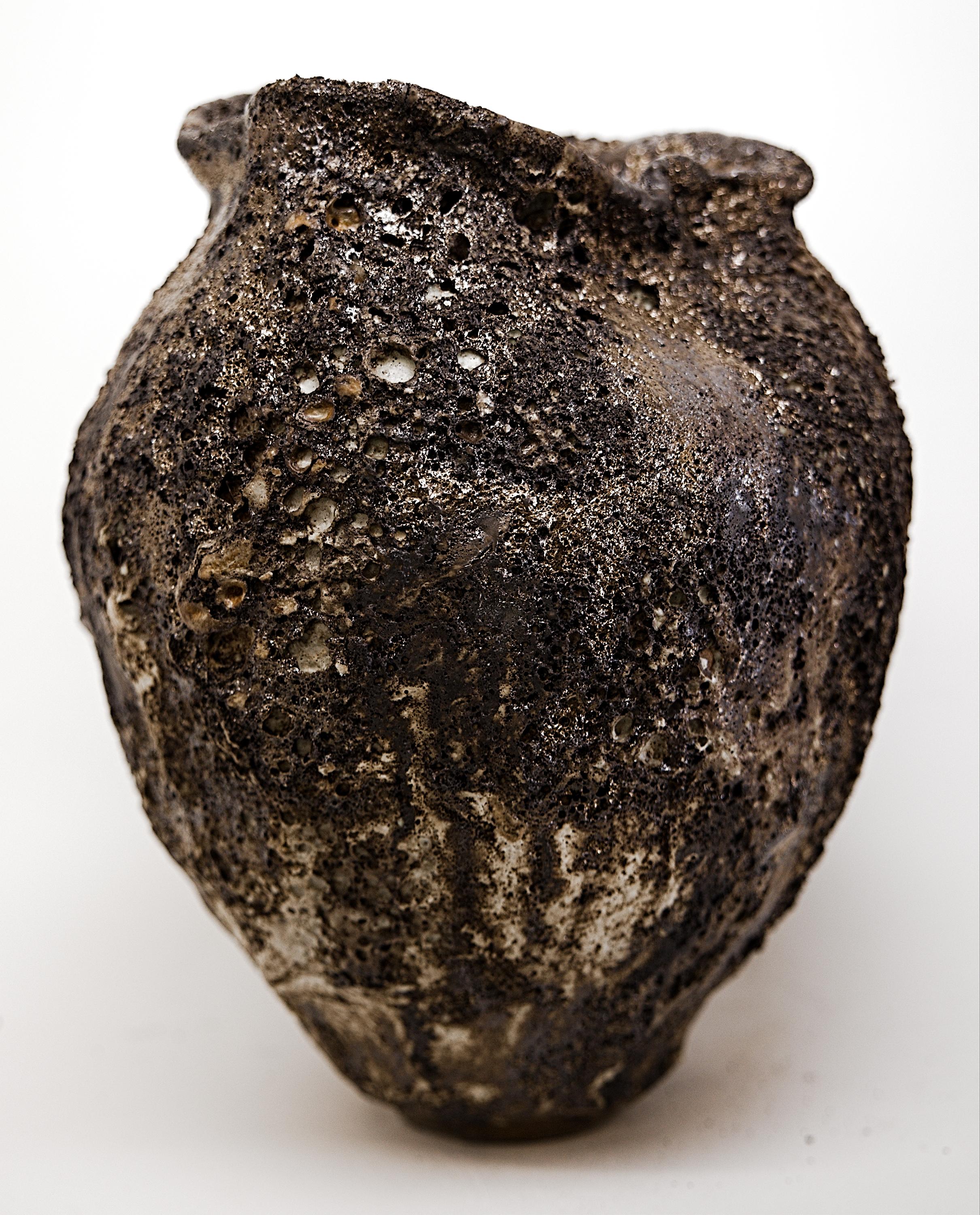 Found like an ancient relic.. created from found clay slabs throughout the studio.
Glazed and finished in old world bronze and mocha mix of color and texture 
on dark chocolate clay.
 
 Elevate your home décor with the Bronze and Black Relics Vase