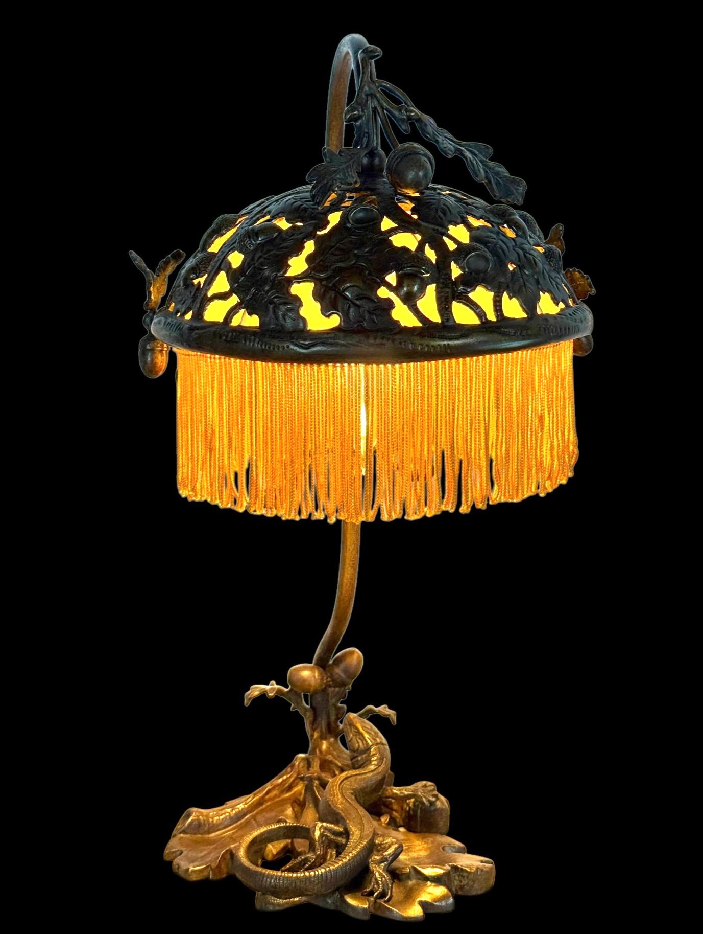 A wonderful bronze lamp in the Aesthetic movement style. Likely dates to the late 19th or early 20th century. I was initially thinking perhaps it was an Austrian Bronze but I believe it is a Victorian Aesthetic lamp. The lizard and acorn motif are