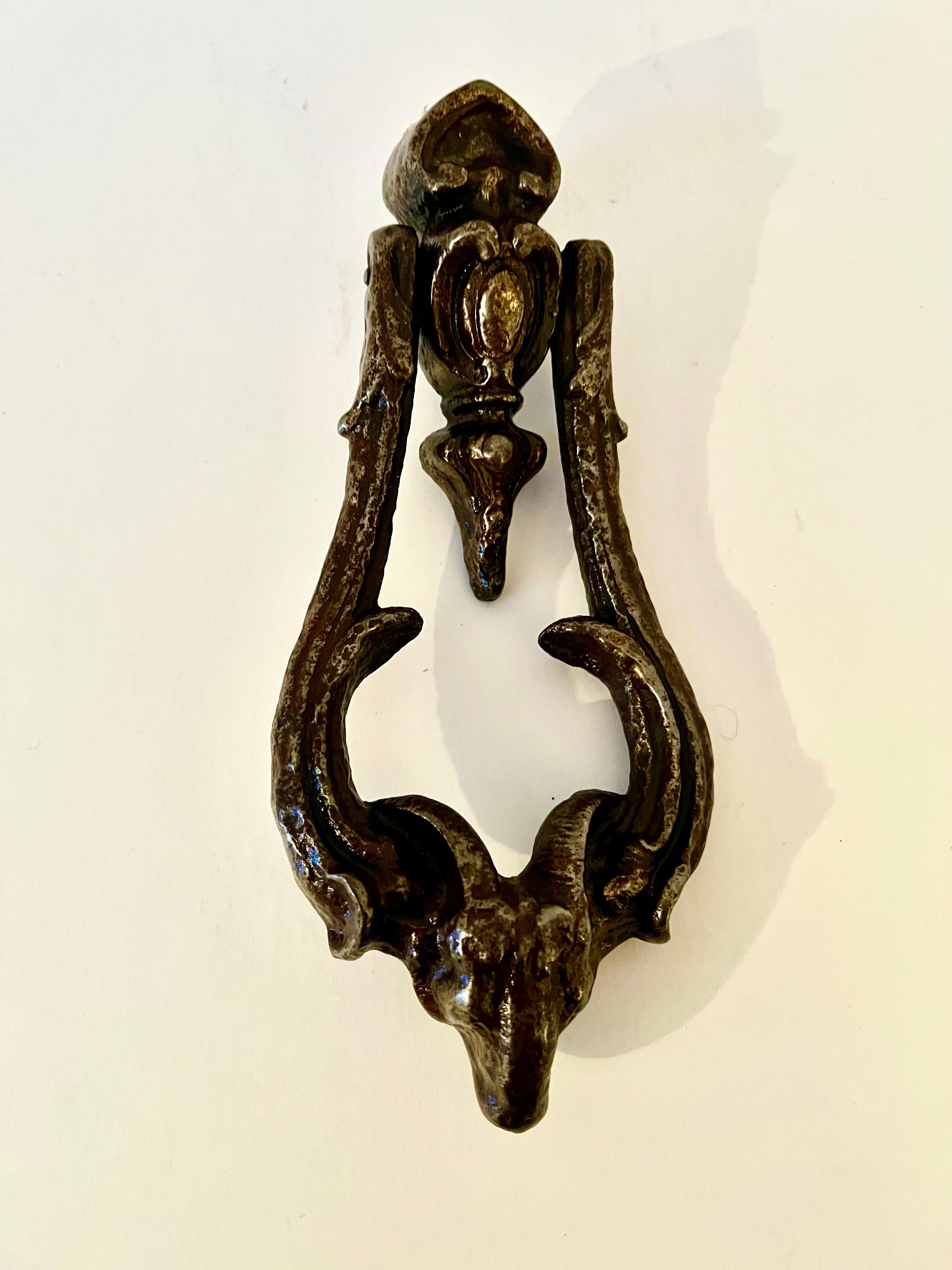 A heavy and substantial door knocker with a lovely ram detail entertained into the design. A great addition to the look of a new home or one that is keeping with the integrity of a period home or brownstone. We sell a lot of door knockers and this