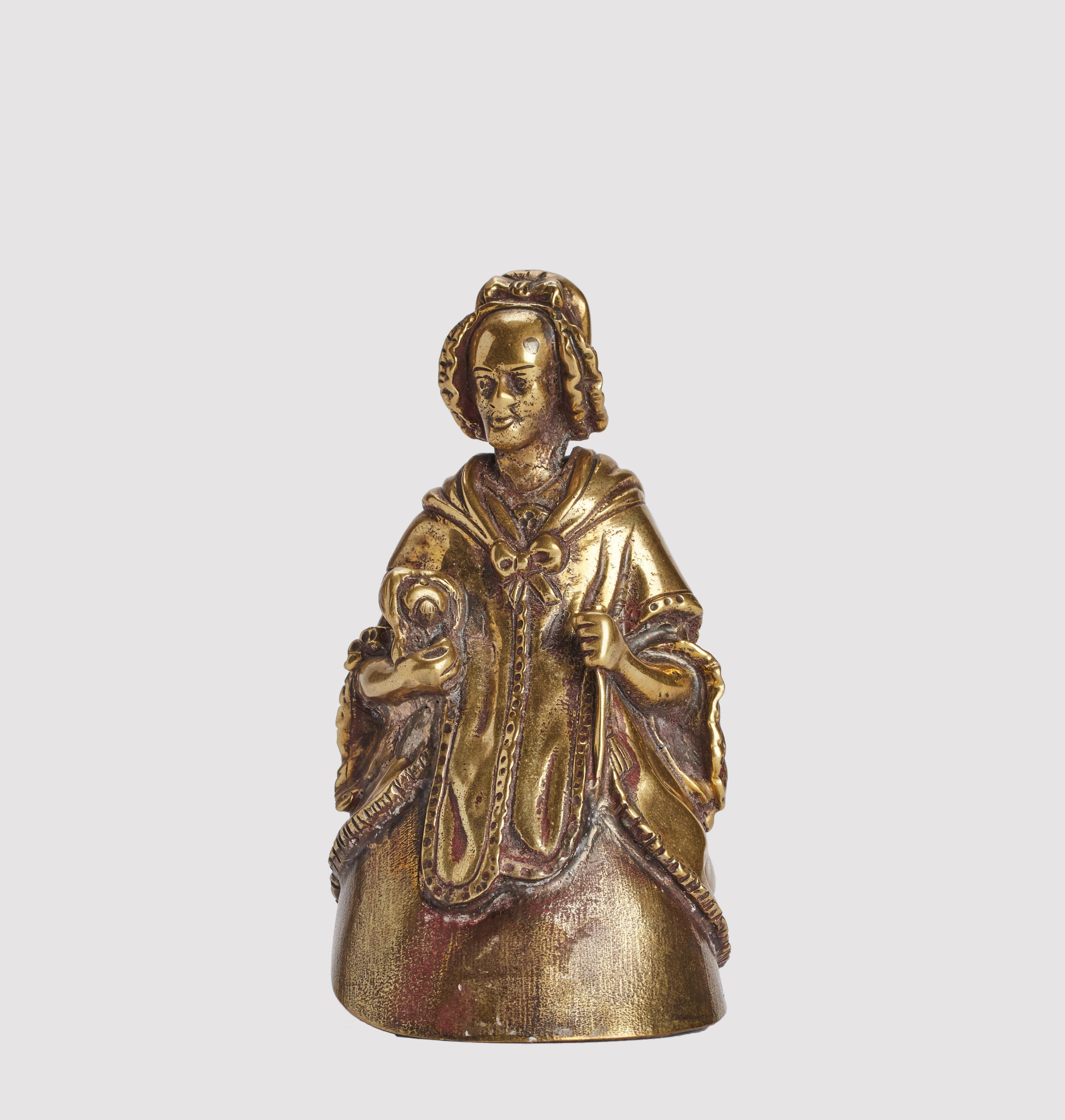 Campana da tavolo vintage in bronzo figurato, raffigurante una donna anziana con una cuffietta e un cane sotto il braccio. Londra, Regno Unito, 1880 circa.