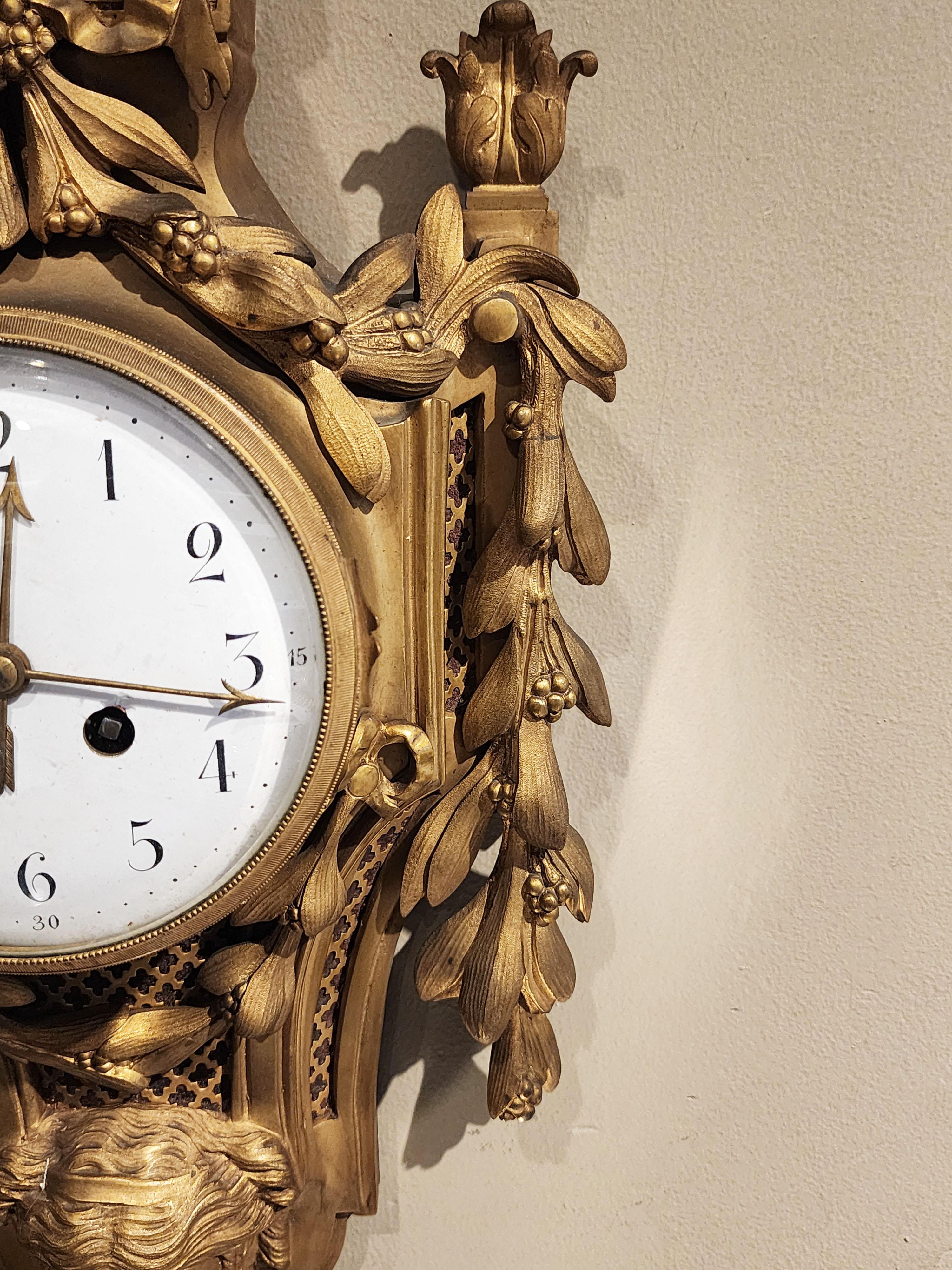 French Bronze wall clock, Louis XVI style with a mask For Sale