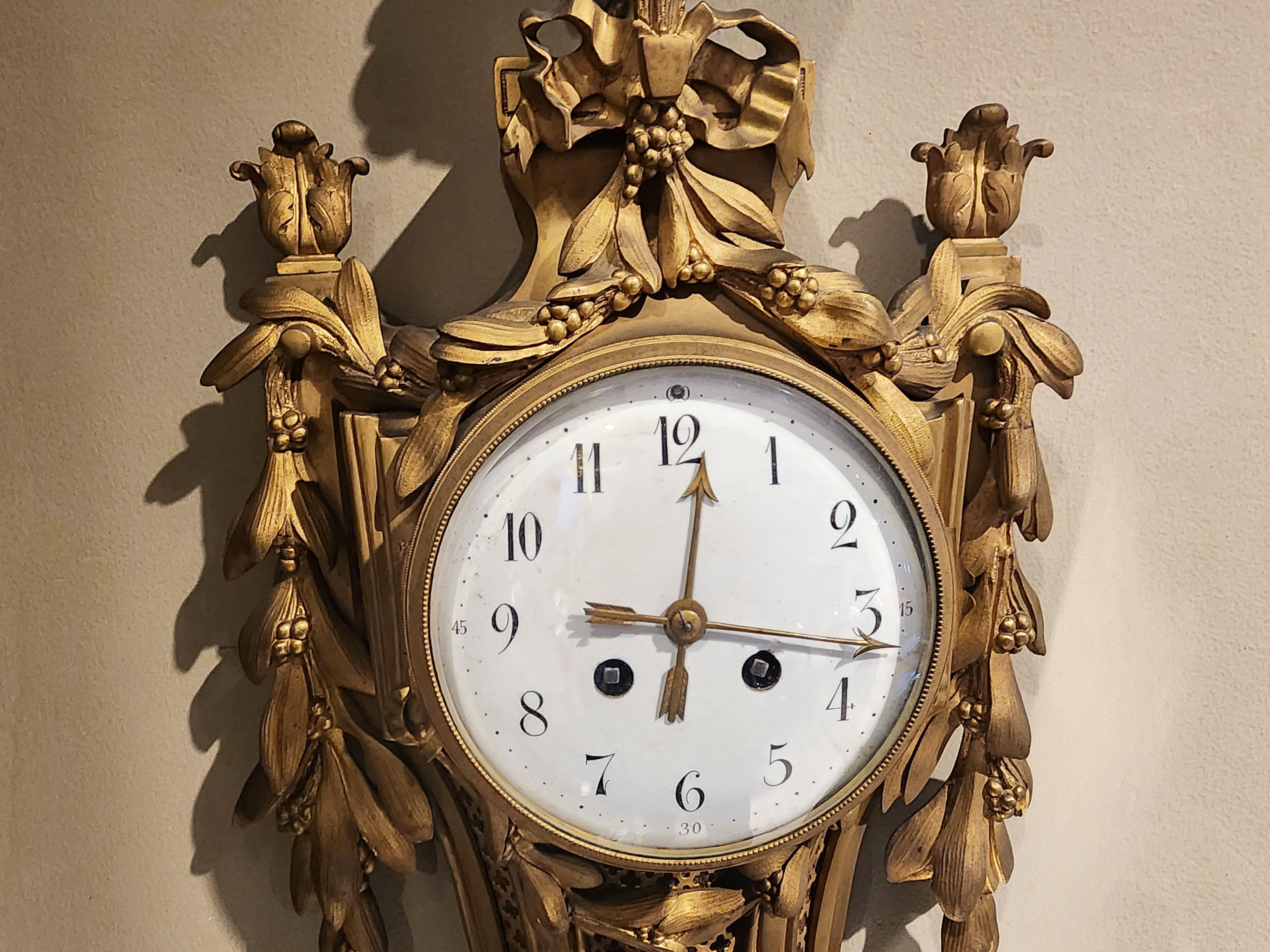 Bronze wall clock, Louis XVI style with a mask In Good Condition For Sale In Autonomous City Buenos Aires, CABA