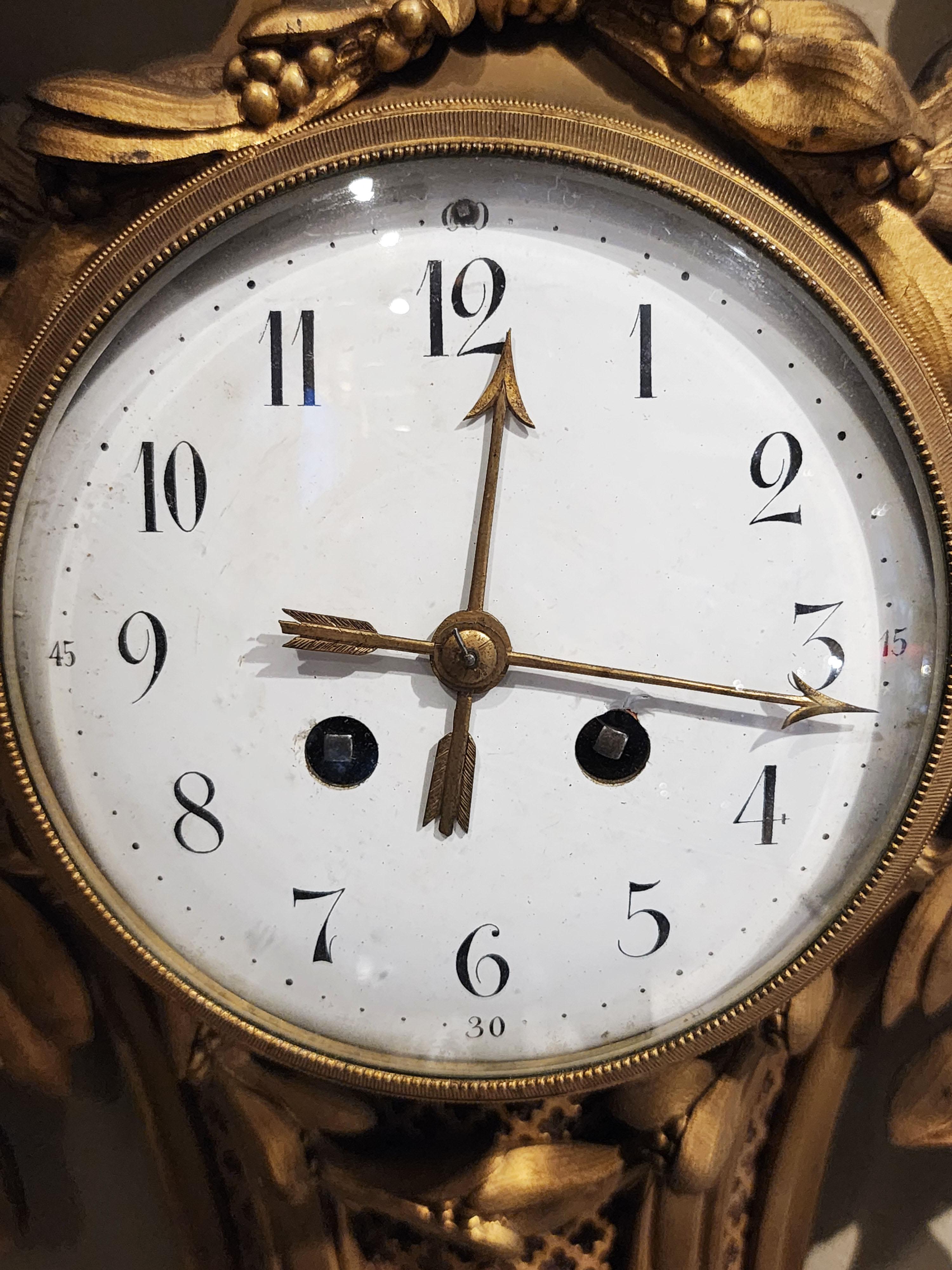 20th Century Bronze wall clock, Louis XVI style with a mask For Sale