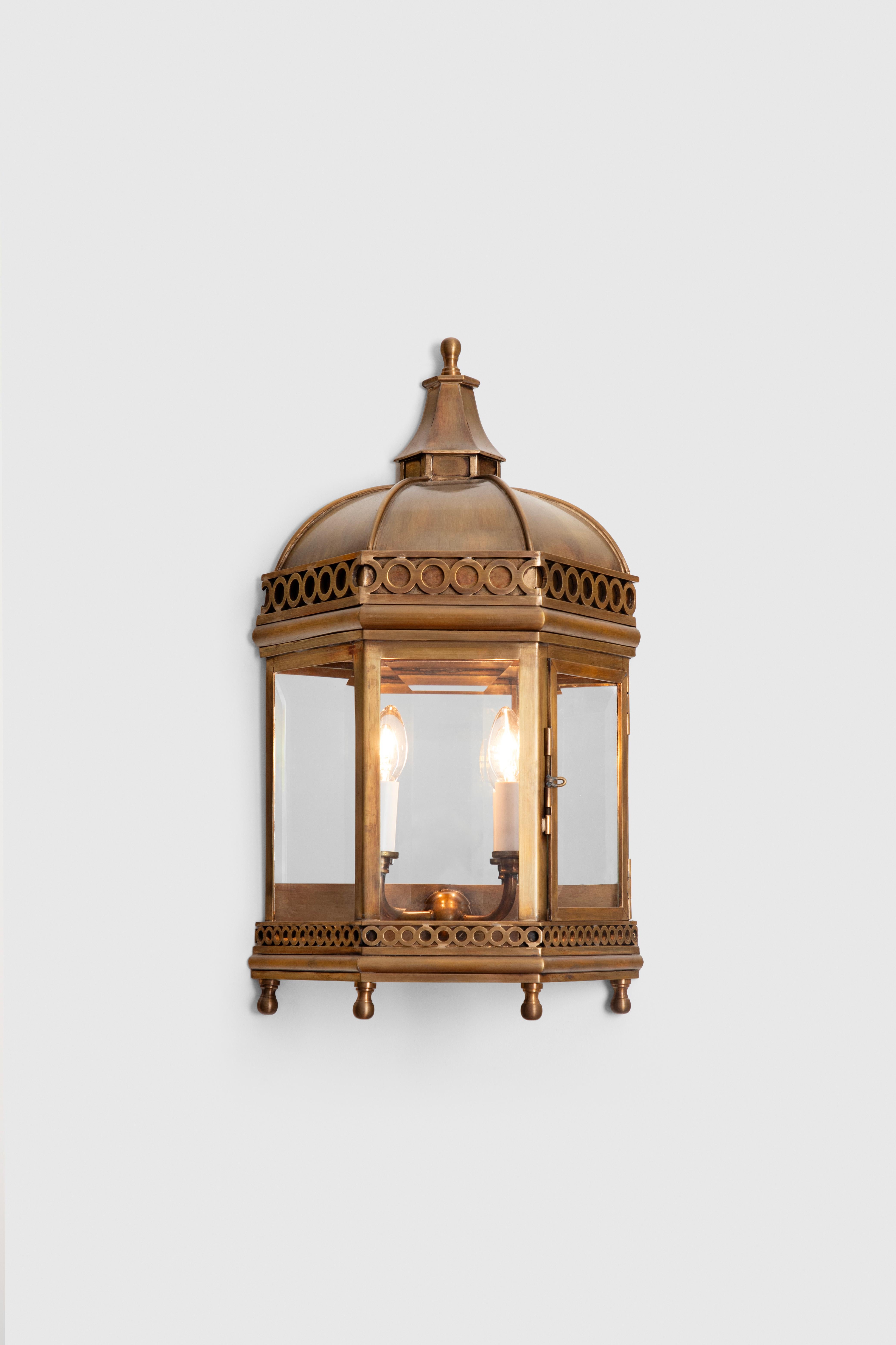 This wall lantern is hand made in bronze by craftsmen in Mexico City. 
Each piece is designed with outmost attention to detail.