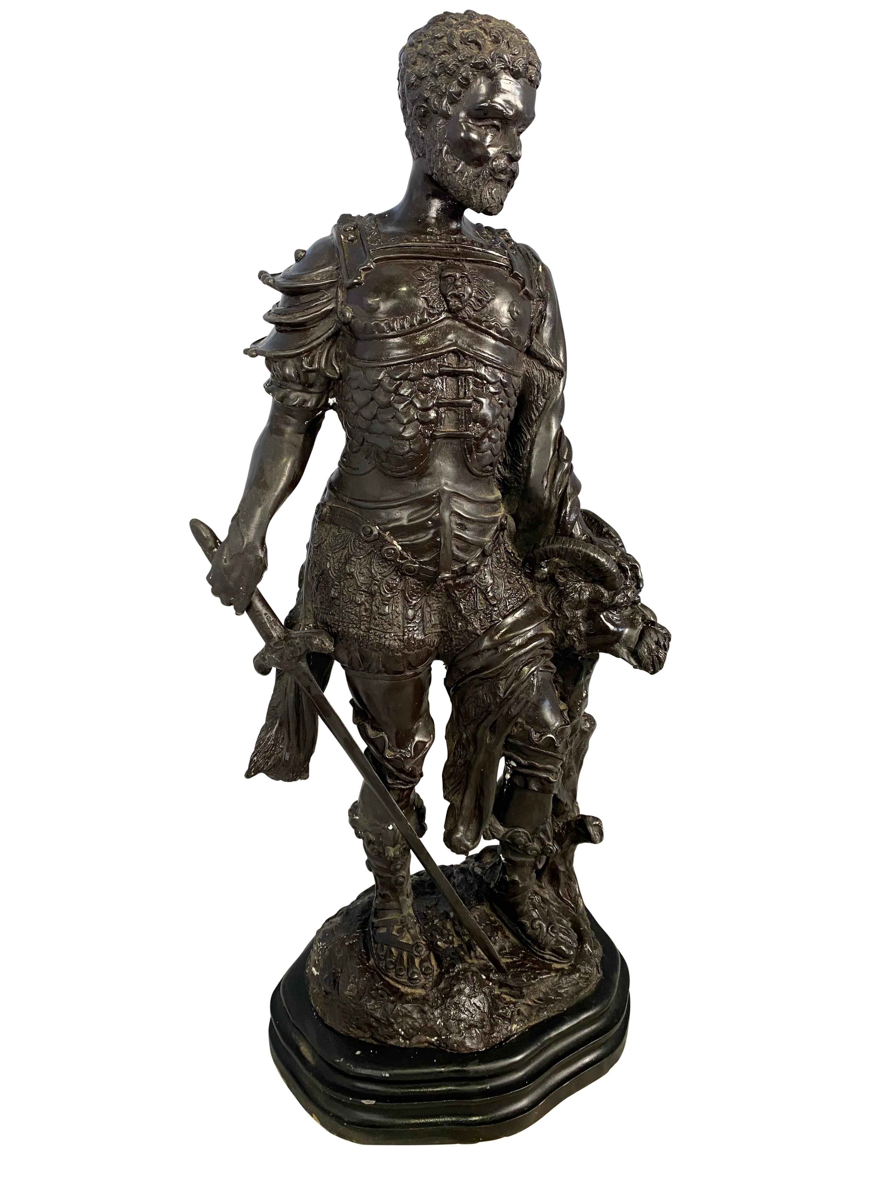 A bronze armoured, bearded warrior stands proud holding his sword in one hand and holding his prize of a Demi-human beast in another. The bronze has exceptional craftsmanship to detail.

Dimensions: (cm)
63 H/32 W/20 D.