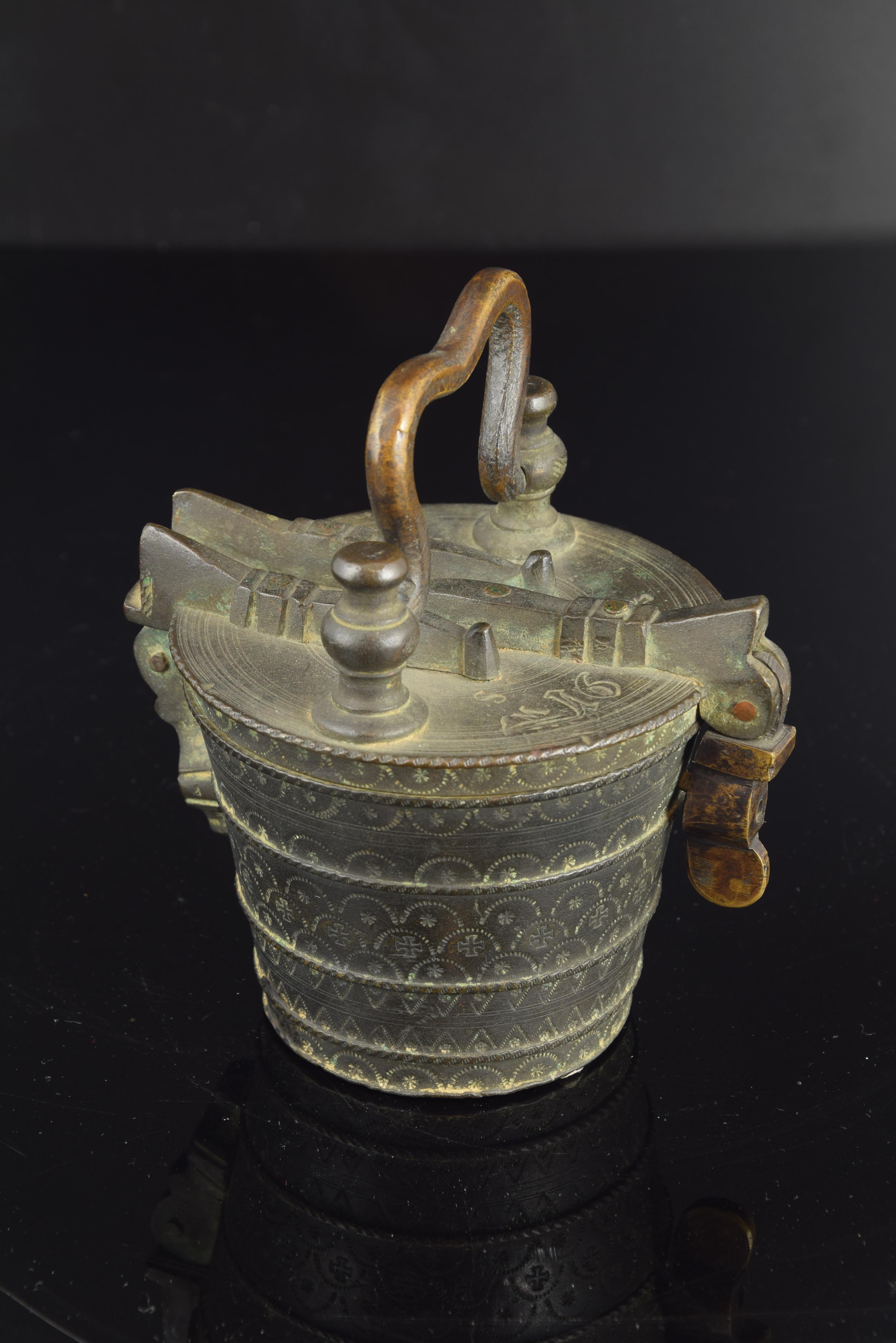 Weight of the 18th century. Bronze.
Bronze weight, incomplete, with the container glass and two of the smallest, all decorated in cold with incised and patterned motifs, simple edges in the small vessels and more complex valances in the container