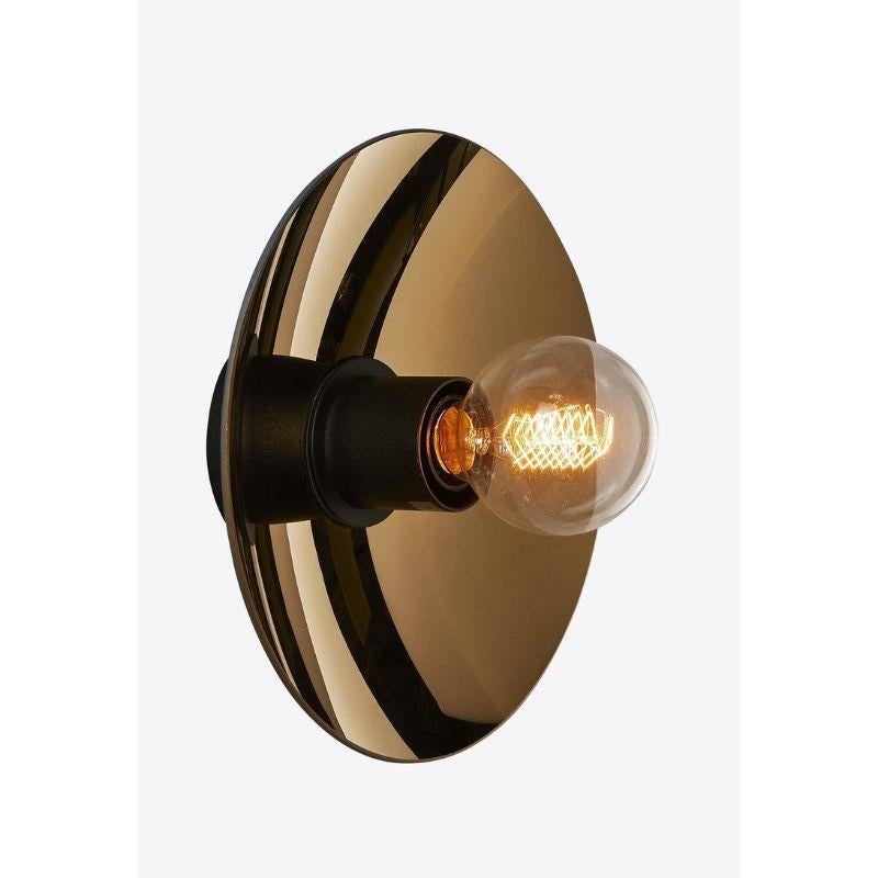 Bronze Zénith wall light, XS by RADAR
Materials: bronze thermoformed glass, matt black metal.
Dimensions: Depth 15 x Diameter 25 cm

Also available: in gold or silver, solid oak or in matt black metal structure.

All our lamps can be wired