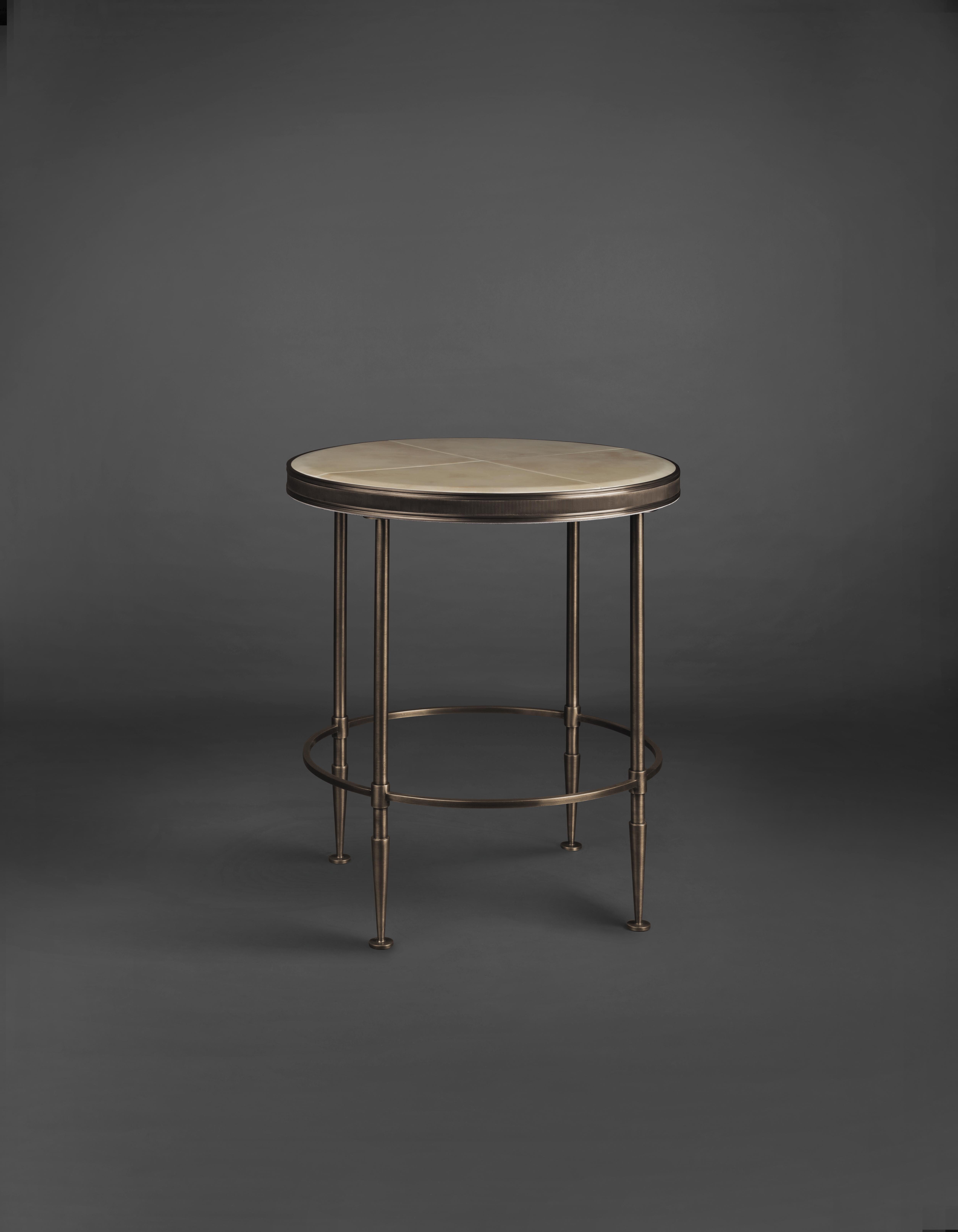 Bronzed finish mandel round table by Madheke
Dimensions: W 55 x D 55 x H 60 cm,
Materials: leather, metal

Bronzed finish framed body with soft edged top of lacquered parchment

Reflecting the finest in craftsmanship, innovation and heritage,