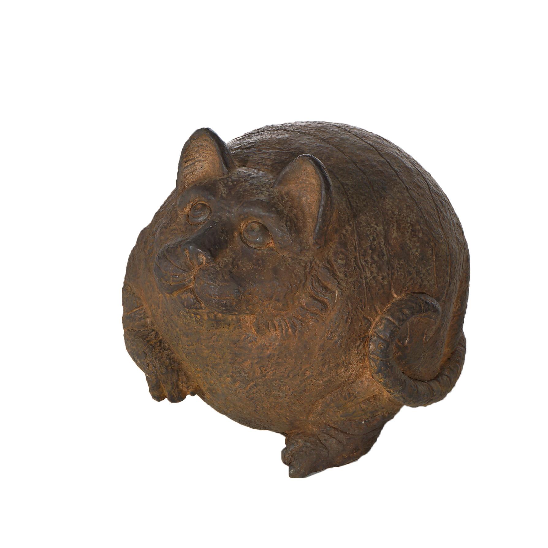A garden statue of a fat cat reminiscent of the Cheshire Cat offers cast hard stone construction in a bronzed finish, 21st century
 
Measures - 11