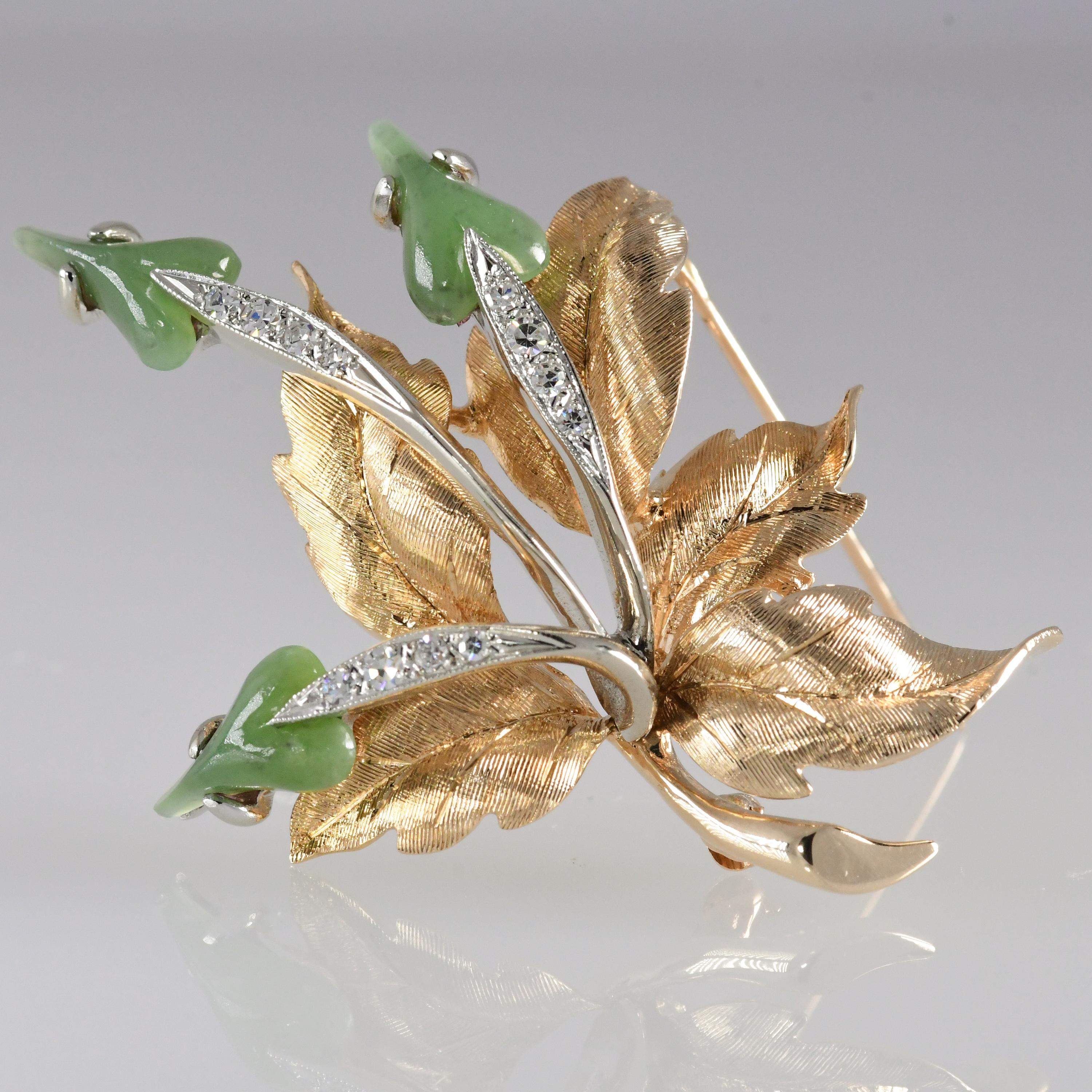  Stunning 14kt yellow gold vintage brooch with jade leaf shaped blossoms, diamond stems, and intricate gold carved leaves, Outstanding design. The diamonds total .20 carat and are VS; G-H quality. The brooch measures 2 inches long and 1 1/2 inch