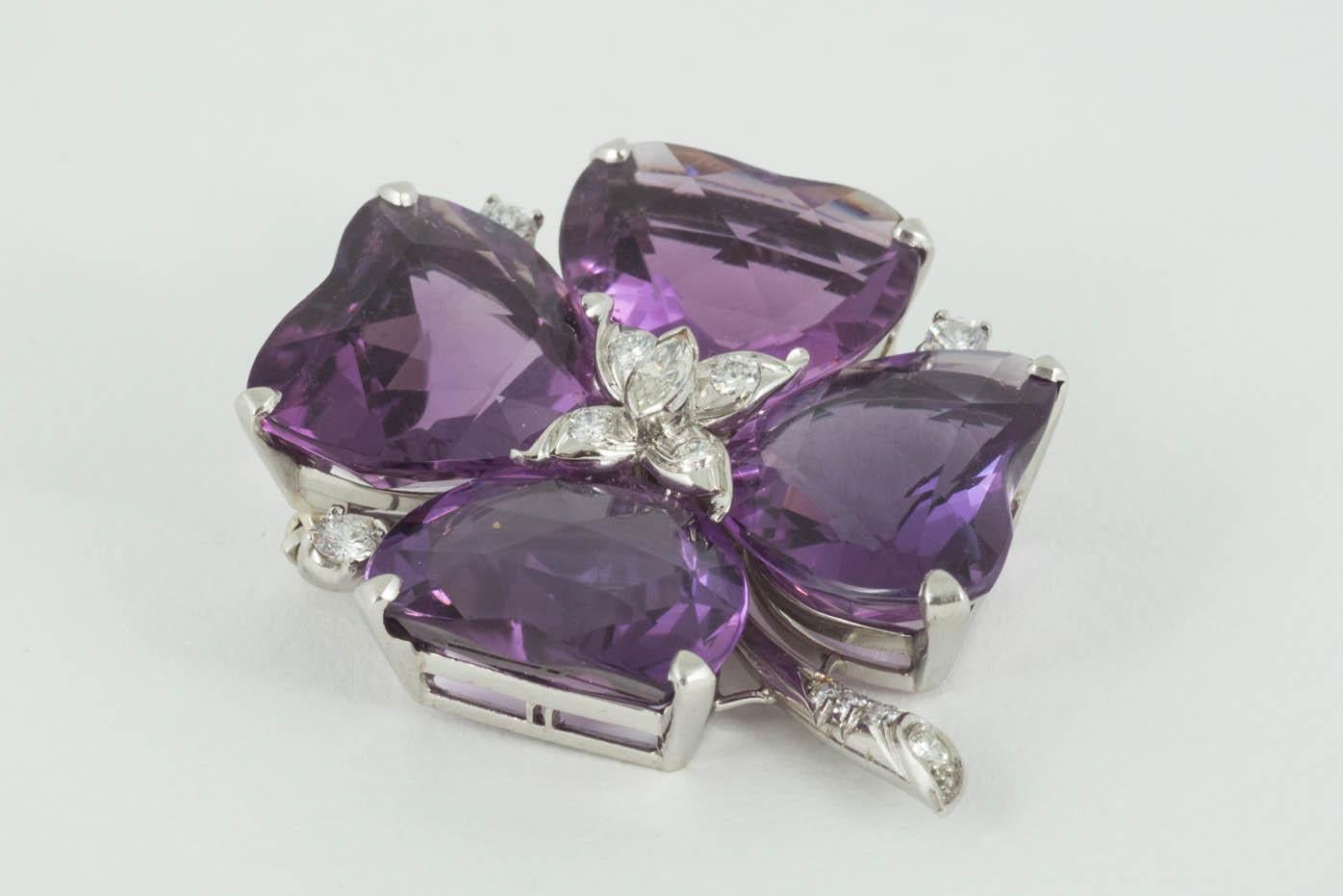 A high quality four leaf clover brooch set with rose cut Amethysts and diamond collets between each stone and the stem. The centre is set with a marquise shaped diamond and four further brilliant cut diamonds. Platinum mark and numbered