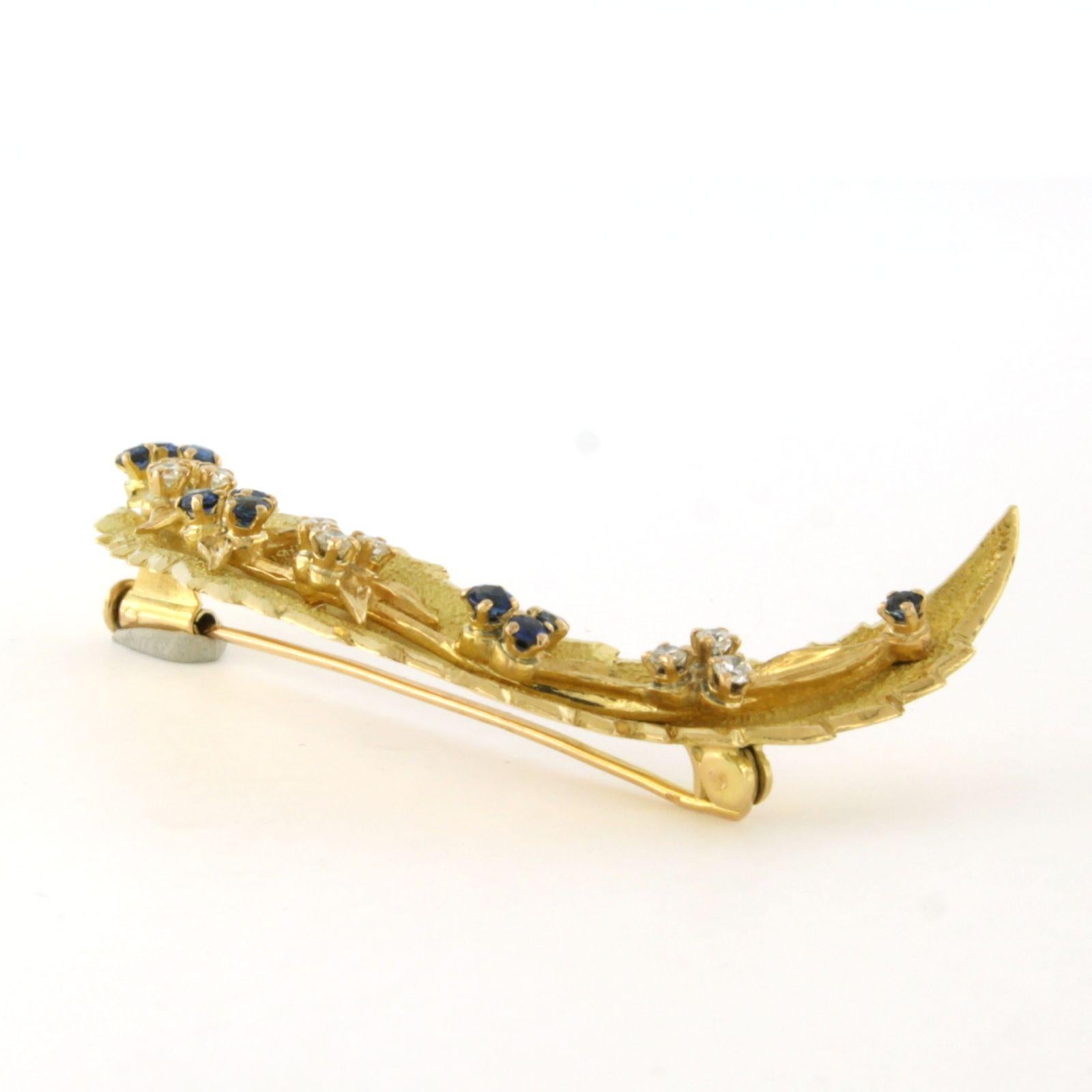 14k yellow gold brooch set with sapphire and brilliant cut diamond up to 0.25 carat - F - VS

detailed description:

The size of the brooch is 6.0 cm by 3.4 cm wide

Weight 11.9 grams

Set with

- 10 x 1.8 mm brilliant cut heated sapphire total
