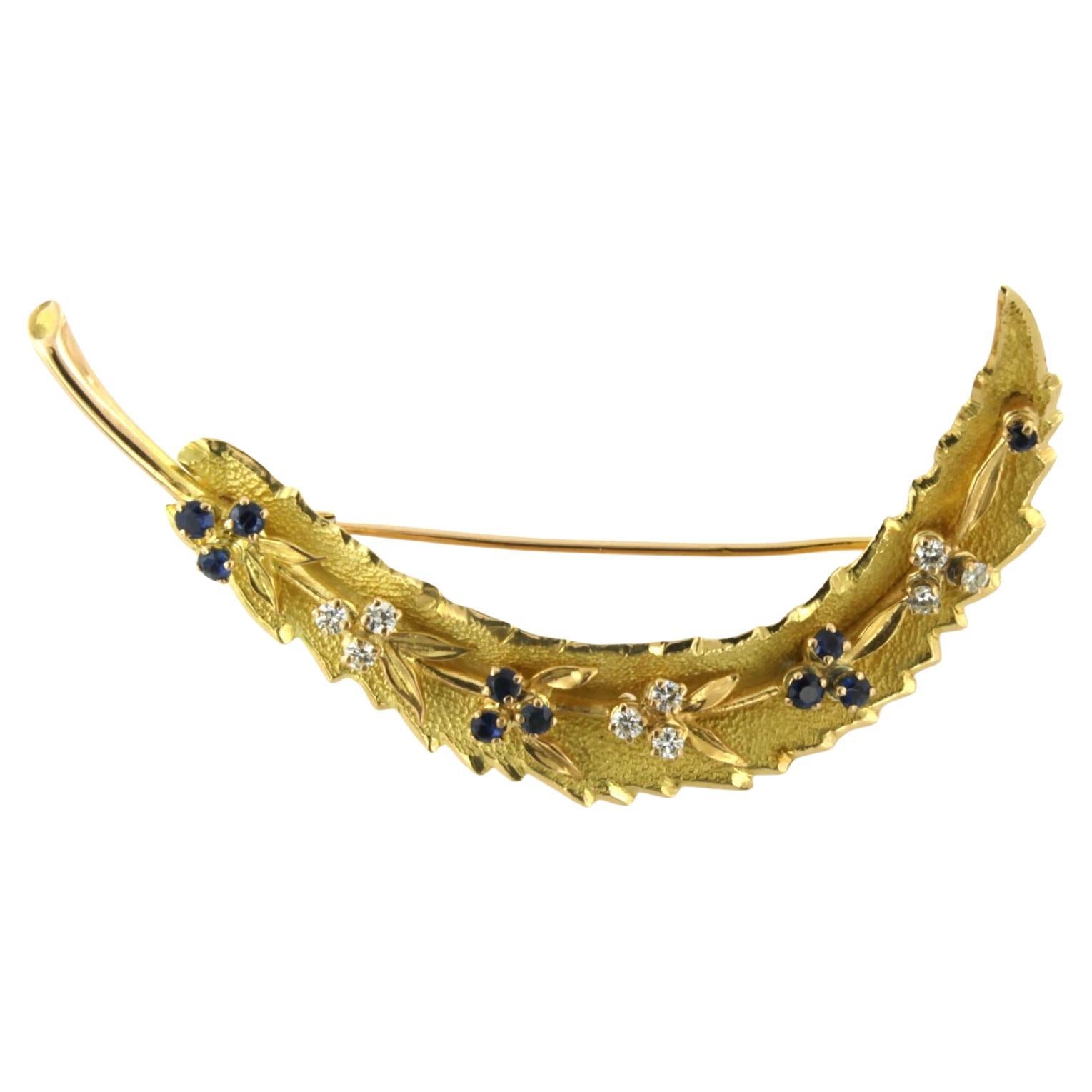Brooch in a shape of a feather with sapphire and brilliant cut diamonds 18k gold