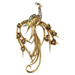 Brooch in a shape of a peacock set with diamonds 18k bicolor gold